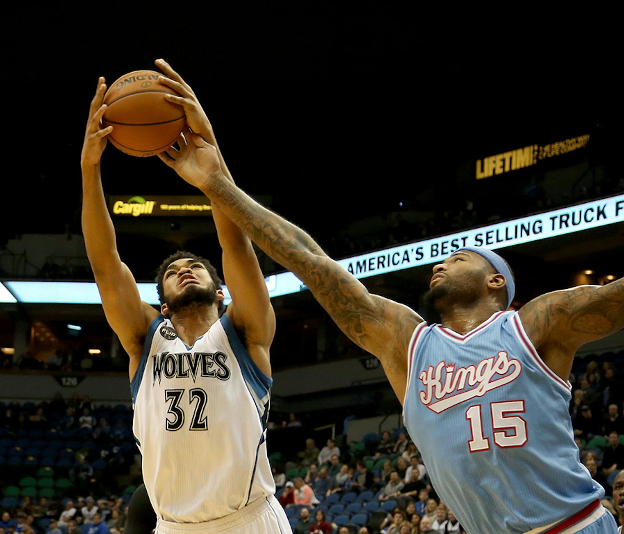 Wolves Karl-Anthony Towns and Sacramento's DeMarcus Cousins fought for a rebound during the first half.