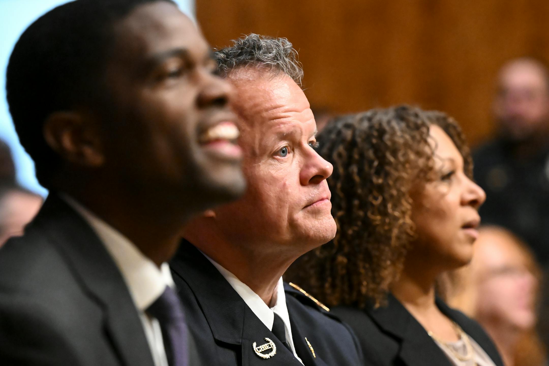 From left, St. Paul Mayor Melvin Carter, St. Paul Police Commander of Narcotics, Financial Intelligence and Human Trafficking Division Axel Henry and Henry's partner, Mikeya Griffin sit in the city council chambers while awaiting a vote confirming Henry as the city's new police chief Wednesday, Nov. 16, 2022 at St. Paul City Hall in St. Paul, Minn..