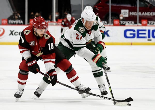 Arizona Coyotes' Derick Brassard (16) and Minnesota Wild's Nick Bjugstad (27) battle for the puck during the second period of an NHL hockey game Tuesd
