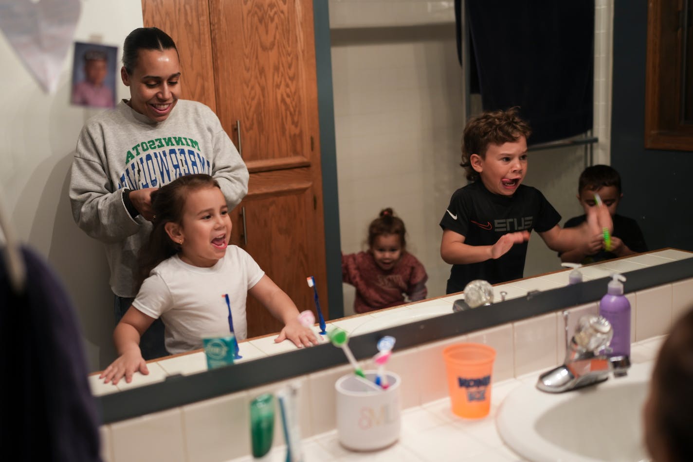 Felicia Krick got her children ready for bed at their home in Eagan. by brushing teeth and braiding hair at home on Tuesday, Dec. 26, 2023 in Eagan, Minn. Children from the left are Crue, 5, Vivi, 3, Grayson, 7, Lincoln, 4.