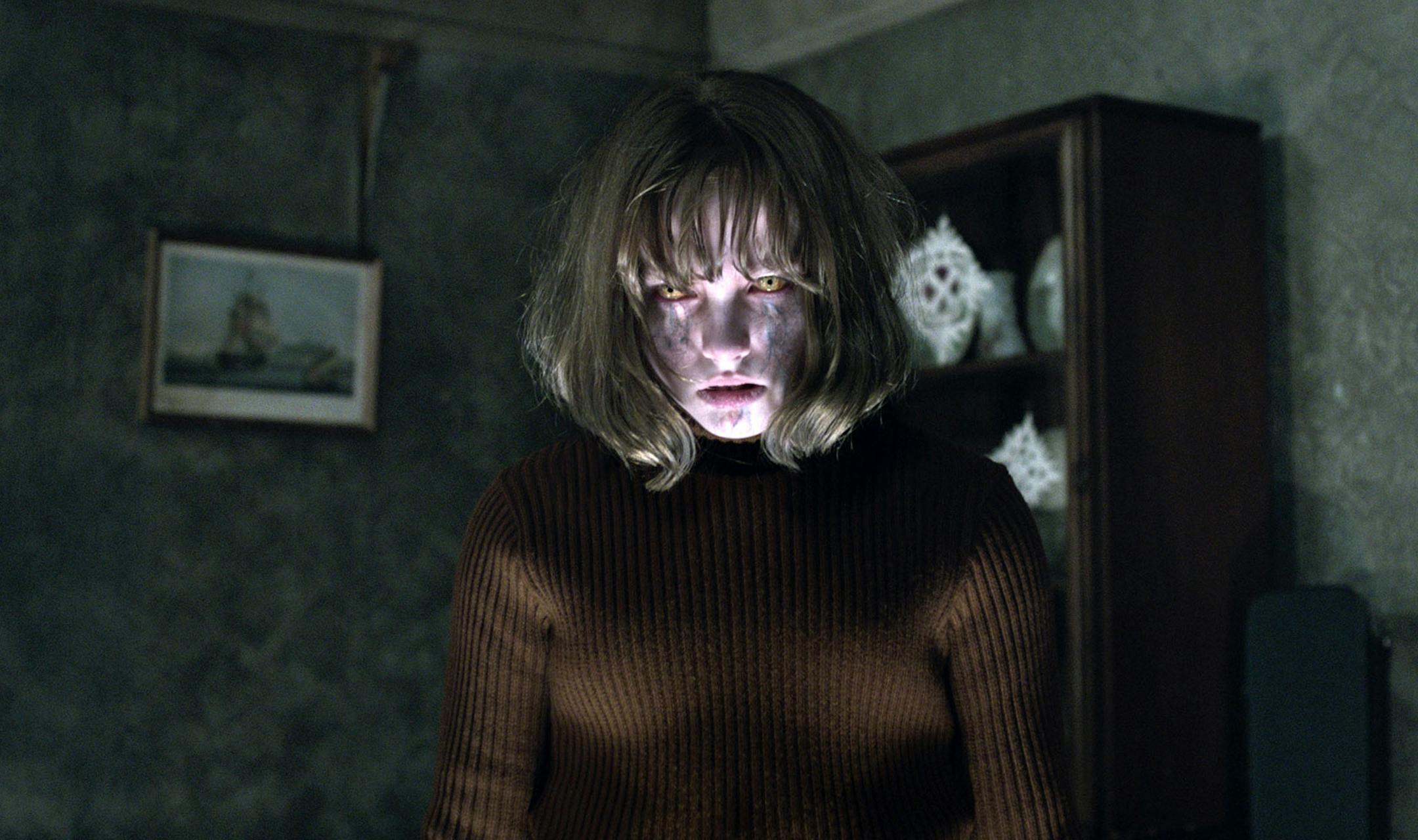 This image released by Warner Bros. shows Madison Wolfe in a scene from the New Line Cinema thriller, "The Conjuring 2." (Warner Bros. via AP)