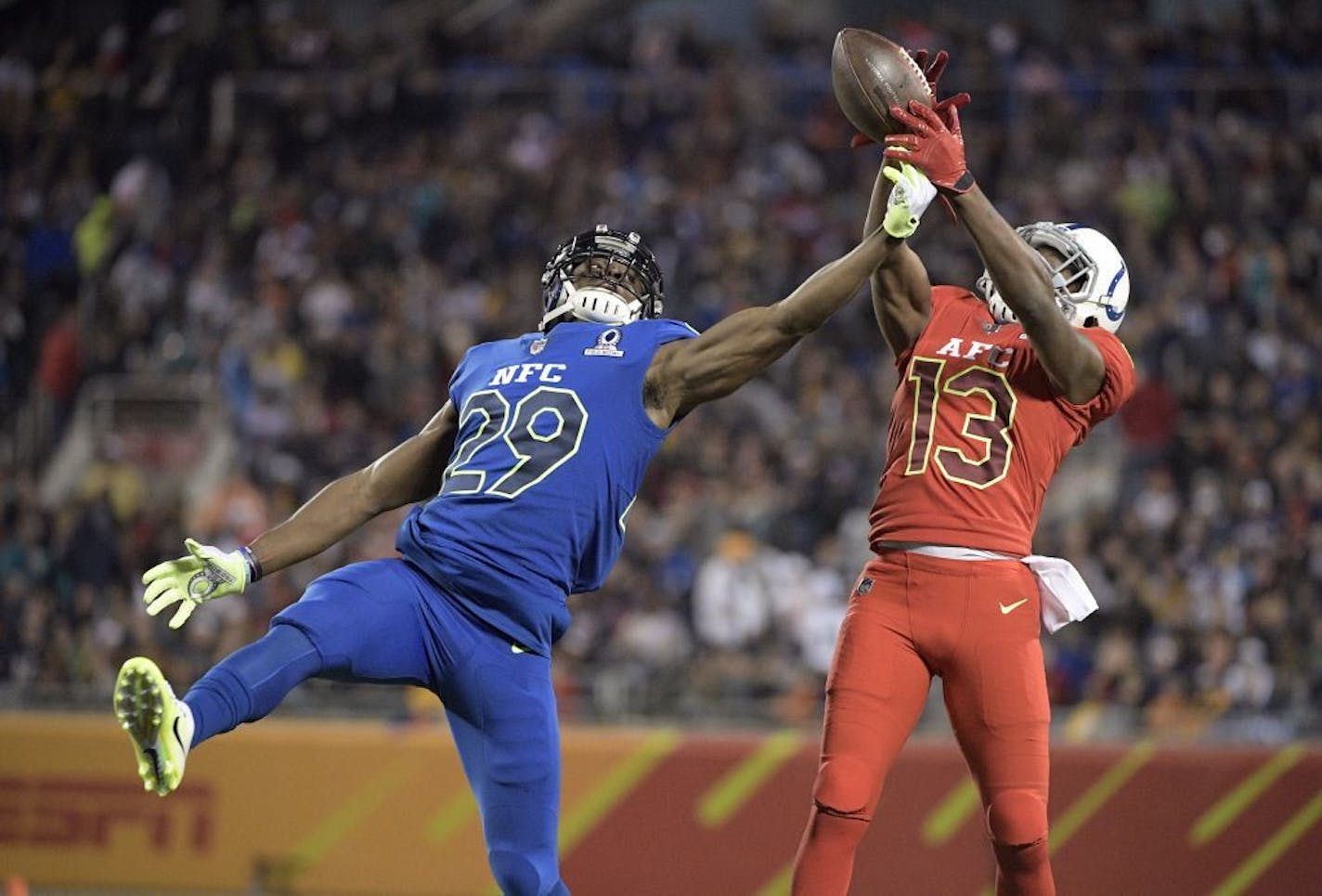 AFC wide receiver T.Y. Hilton (13), of the Indianapolis Colts, attempts to grab a pass, as NFC cornerback Xavier Rhodes (29), of the Minnesota Vikings, defends, during the first half of the NFL Pro Bowl football game Sunday, Jan. 29, 2017, in Orlando, Fla.