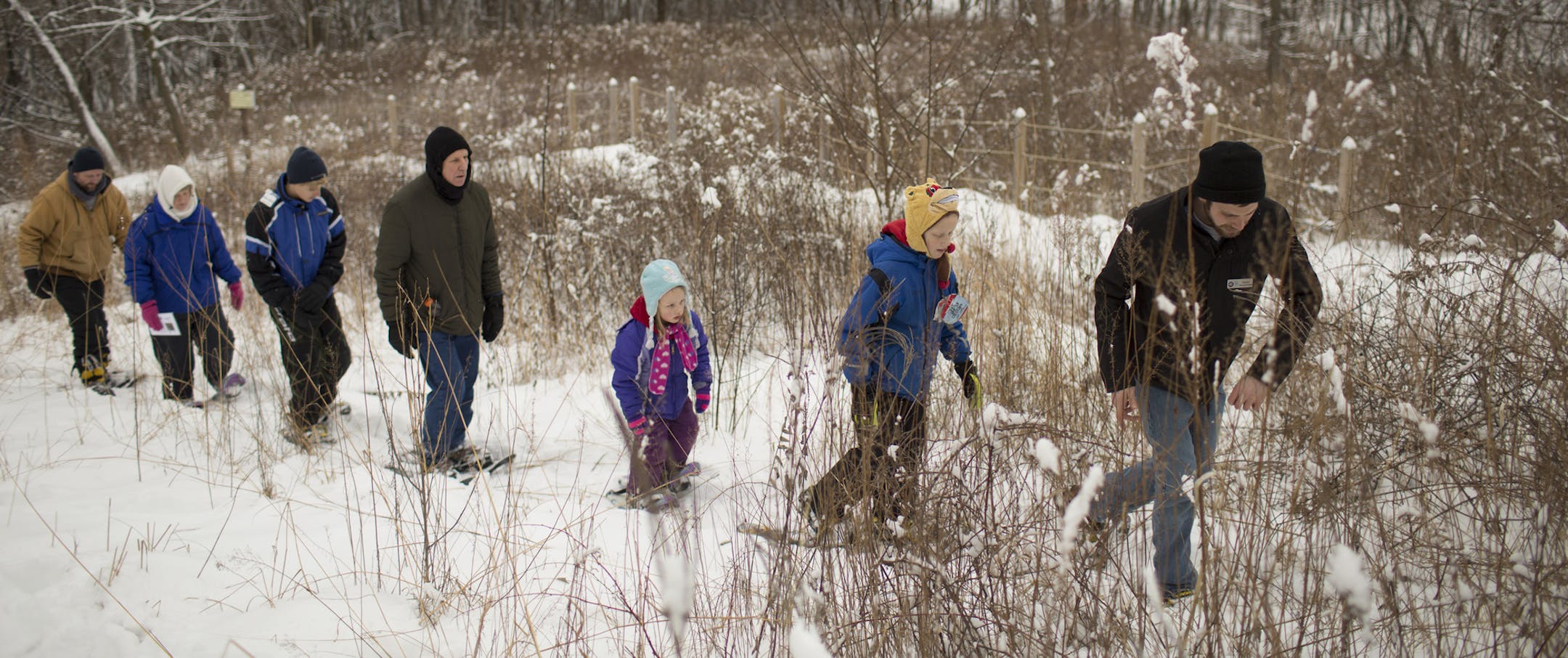 Patrick Bryant, urban program coordinator at the Minnesota Valley National Wildlife Refuge in Bloomington, led Grant Batchelder, 10, his sister, Shania, 6, Paul Drew, Cole Drew, Becky Batchelder and Craig Batchelder, front to rear, on a "Tracks, Scat, and All That Hike" in the freshly fallen snow Tuesday afternoon. ] JEFF WHEELER ï jeff.wheeler@startribune.com The Minnesota Valley National Wildlife Refuge in Bloomington hosted a Winter Fun Day on Tuesday, December 29, 2015 with programing f