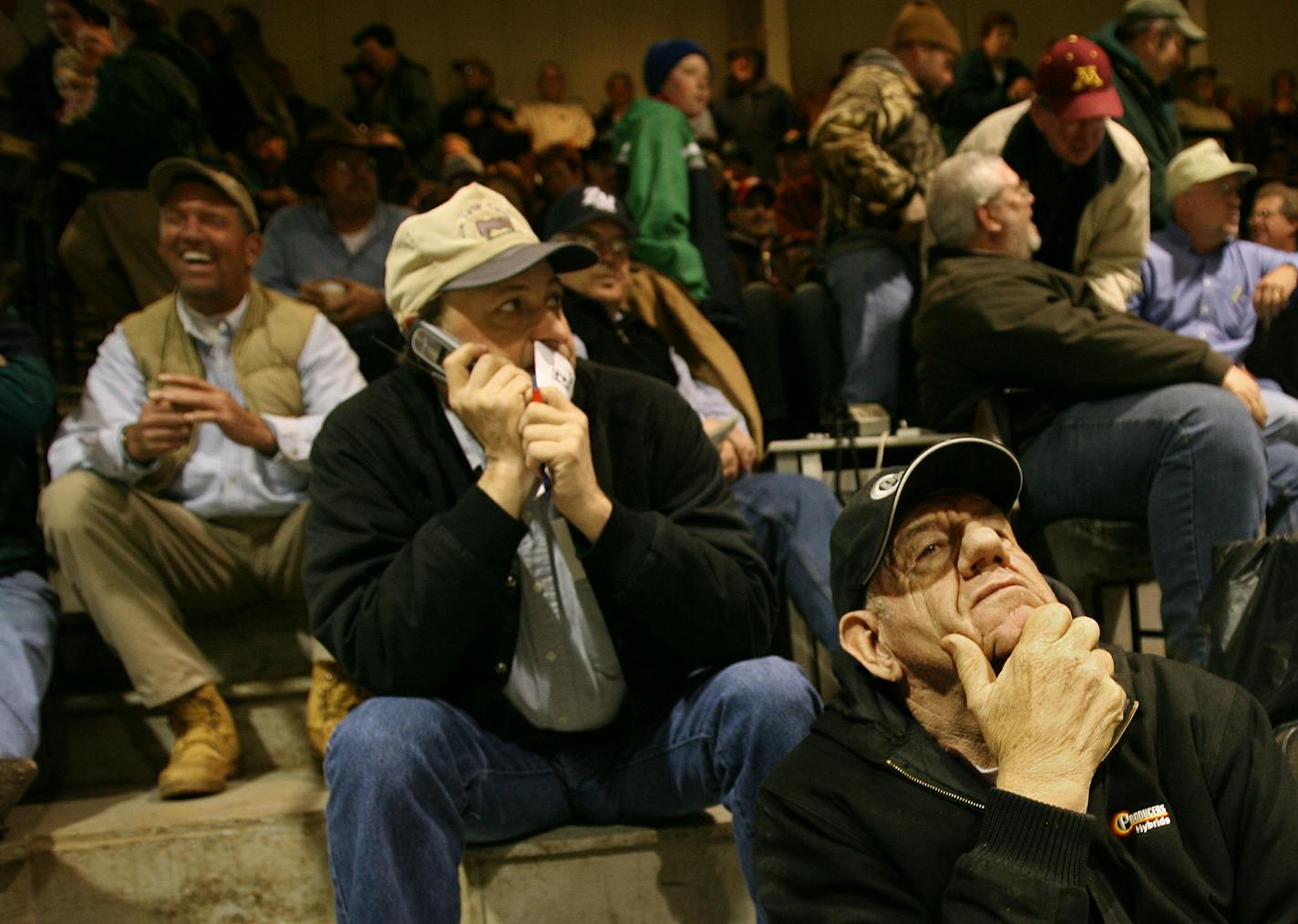 A mixture of melancholy and celebration hung in the air as the South St. Paul stockyards held their last livestock auctions Friday, after 122 years. Among the bidders in the auction barn were Gene Krismer of Zumbro Falls, lower right, and Joe Varner of Pierz, Minn. Krismer owns a trucking company and has done business at the stockyards over the years. "It's kind of a sad day," he said.