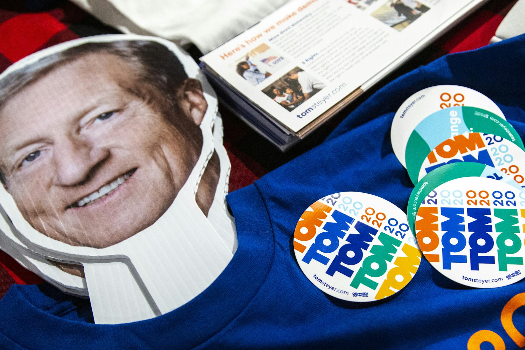 Stickers and a cardboard cutout of Democratic presidential candidate Tom Steyer sit on a table during a campaign event, Sunday, Dec. 8, 2019 at the Java House in Iowa City, Iowa. (Joseph Cress/Iowa City Press-Citizen via AP)