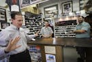 CEO Lee Schram of Deluxe Corp chatted about skating with George's Shoe Repair owners Chris George and Brian George at their shop on Grand Avenue near 