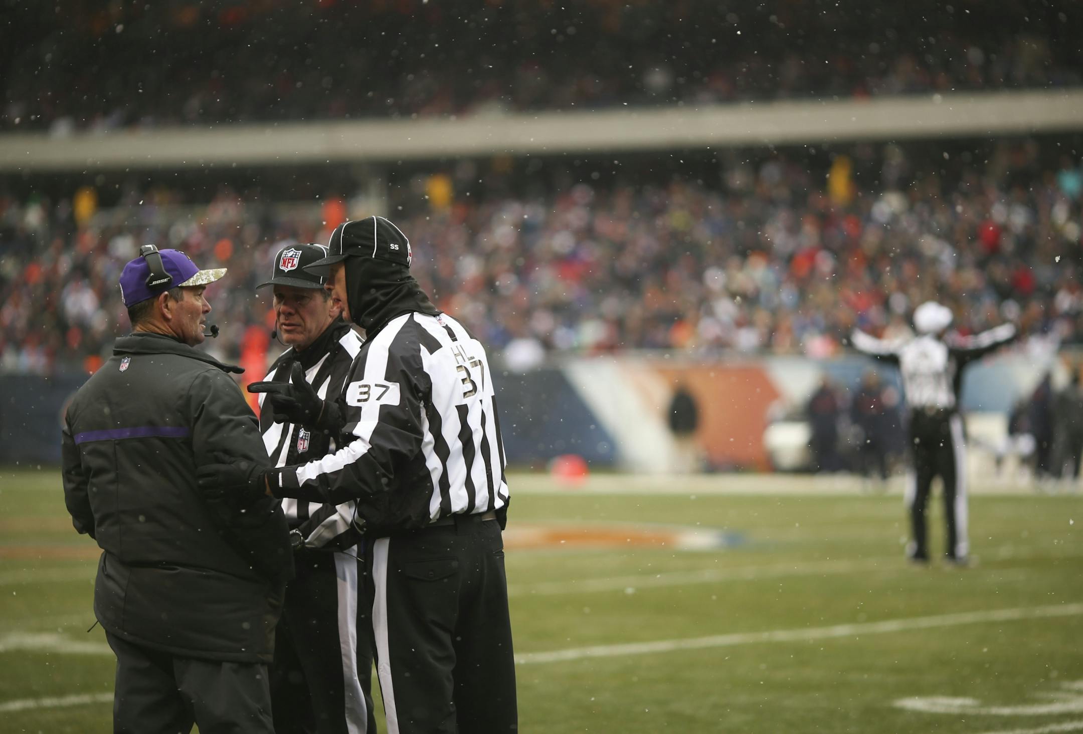 Minnesota Vikings head coach Mike Zimmer conferred with side judge Scott Edwards and head linesman Jim Howey, right, after he challenged a play in the first quarter Sunday afternoon at Soldier Field in Chicago.