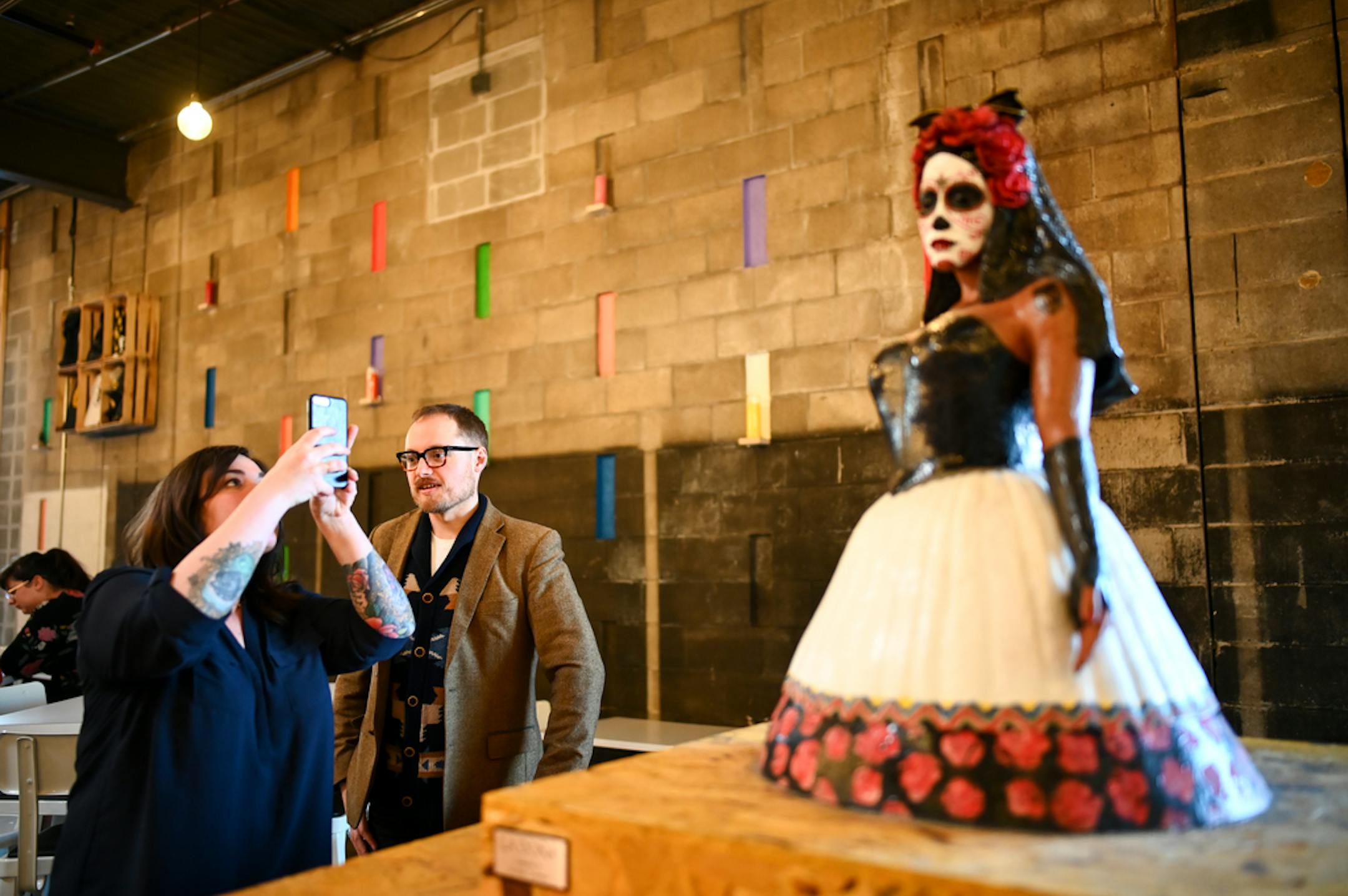 Andrew Park watched as Ashlea Halpern took photos of a sculpture at La Dona Cervesaria Thursday night. ] Aaron Lavinsky ¥ aaron.lavinsky@startribune.com Ashlea Halpern and her partner Andrew Park are travel writers for major national magazines. After living all over the world, they decided to move back to the U.S. Guided by an elaborate spreadsheet, they embarked on a yearlong road trip to check out 229 cities and towns before settling on...Minneapolis! Since settling in a year ago, they've beco