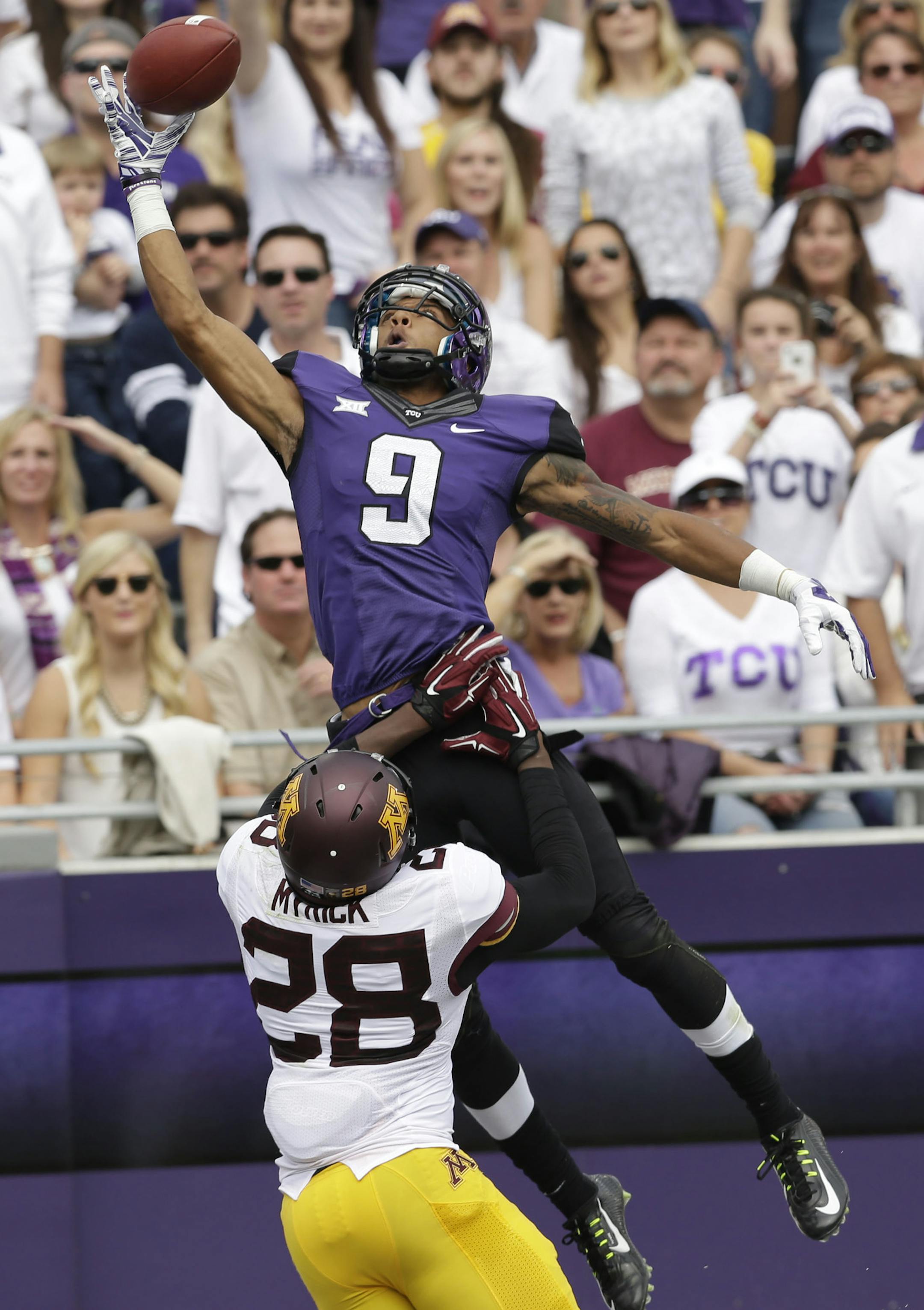 TCU wide receiver Josh Doctson (9) jumps to one-hand catch a touchdown pass over Minnesota defensive back Jalen Myrick (28) during the second quarter of an NCAA college football game, Saturday, Sept. 13, 2014, in Fort Worth, Texas. (AP Photo/LM Otero)