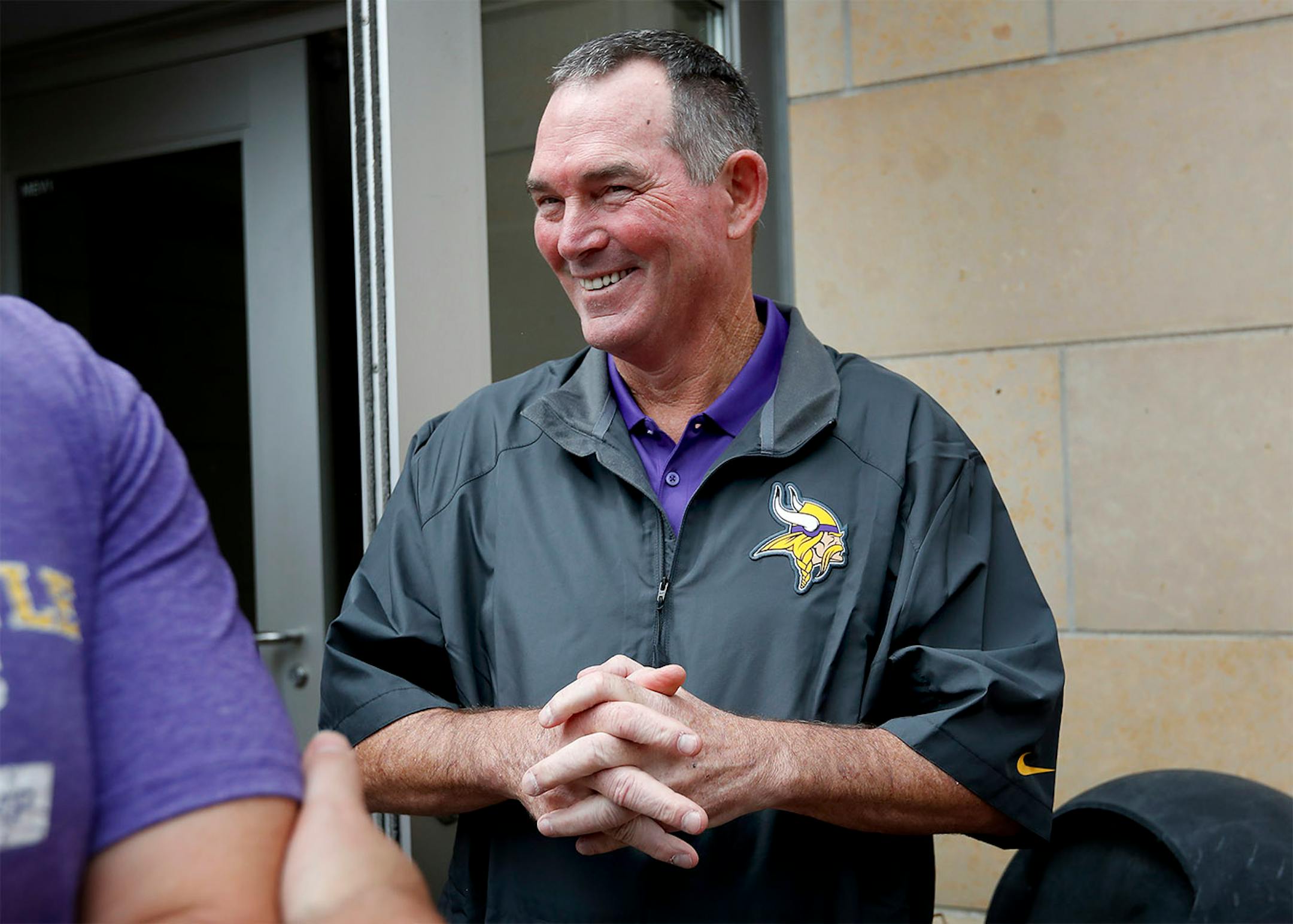 Minnesota Vikings head coach Mike Zimmer reacted as general manager Rick Spielman spoke to the media about Zimmer's contract extension.