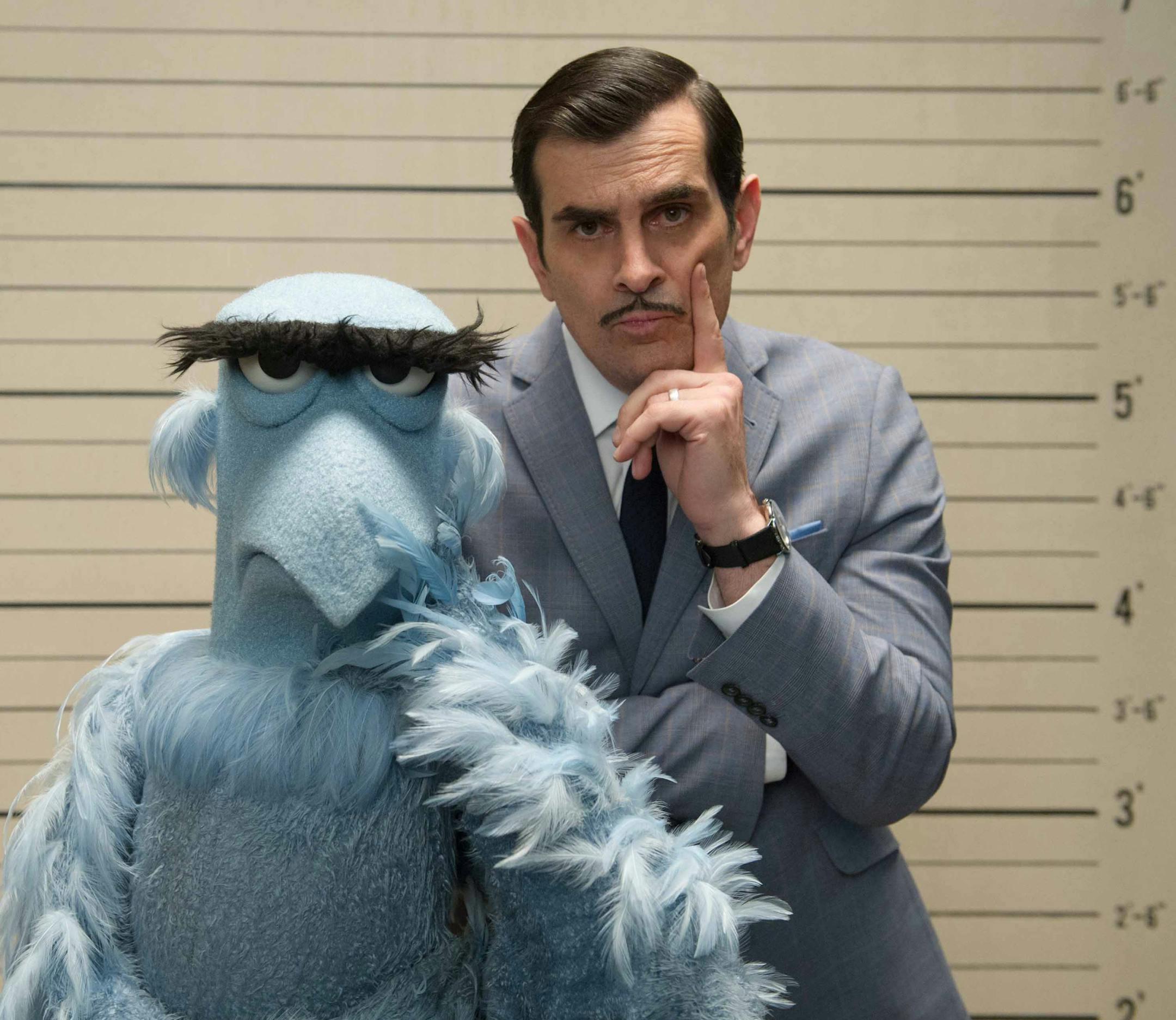 This image released by Disney shows the muppet character Sam the Eagle, left, with Ty Burrell in a scene from "Muppets Most Wanted." (AP Photo/Disney Enterprises, Inc.)