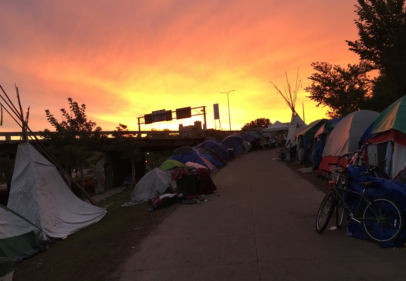 Dawn at the large homeless camp along Hiawatha Avenue in south Minneapolis. The population of the camp has shrunk by more than half in recent months to less than 120 people, the result of a massive outreach effort to help dozens of camp residents find stable housing.