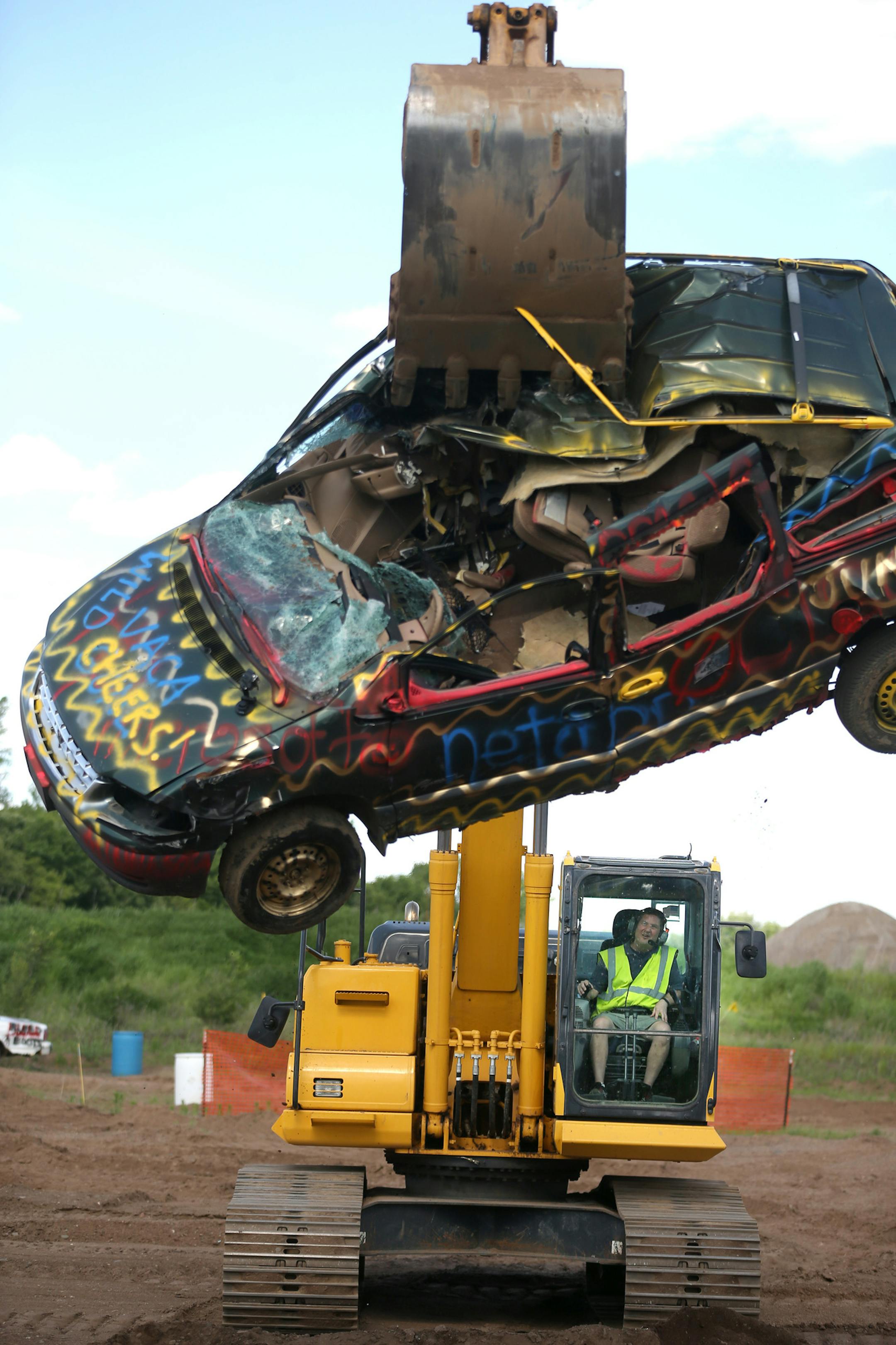 Mike Cossette used an excavator to smash a van while taking part in a team building event at Extreme Sandbox Tuesday June 8, 2016 in Hastings, MN.] Extreme Sandbox in Hastings, offers one of the most unusual experiences for dads at chance to operate full-size excavators, loaders, and bulldozers on 10 acres of dirt and mud. Jerry Holt /Jerry.Holt@Startribune.com