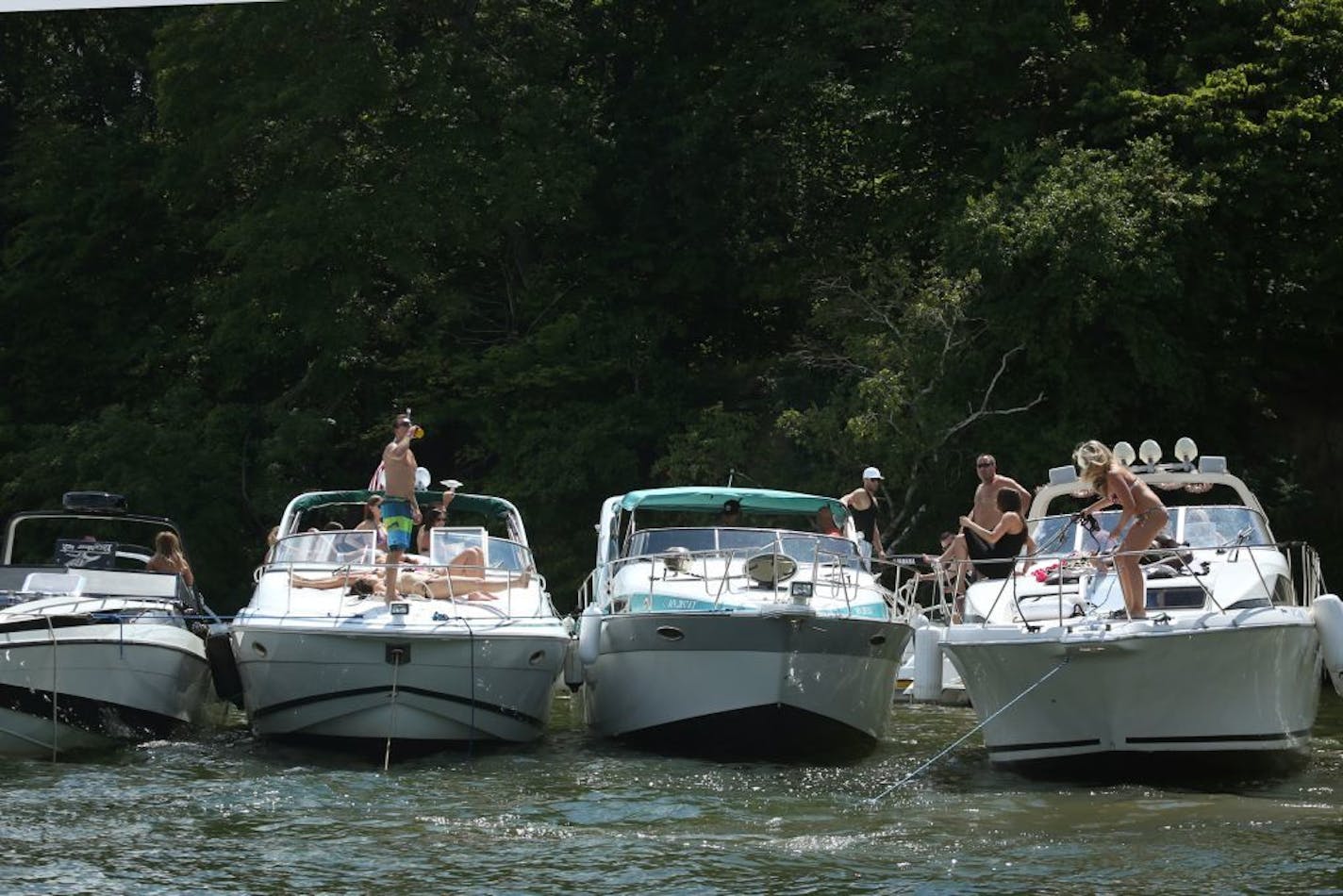 Boats line up, tied together on Lake Minnetonka on Saturday, August 3, 2013.