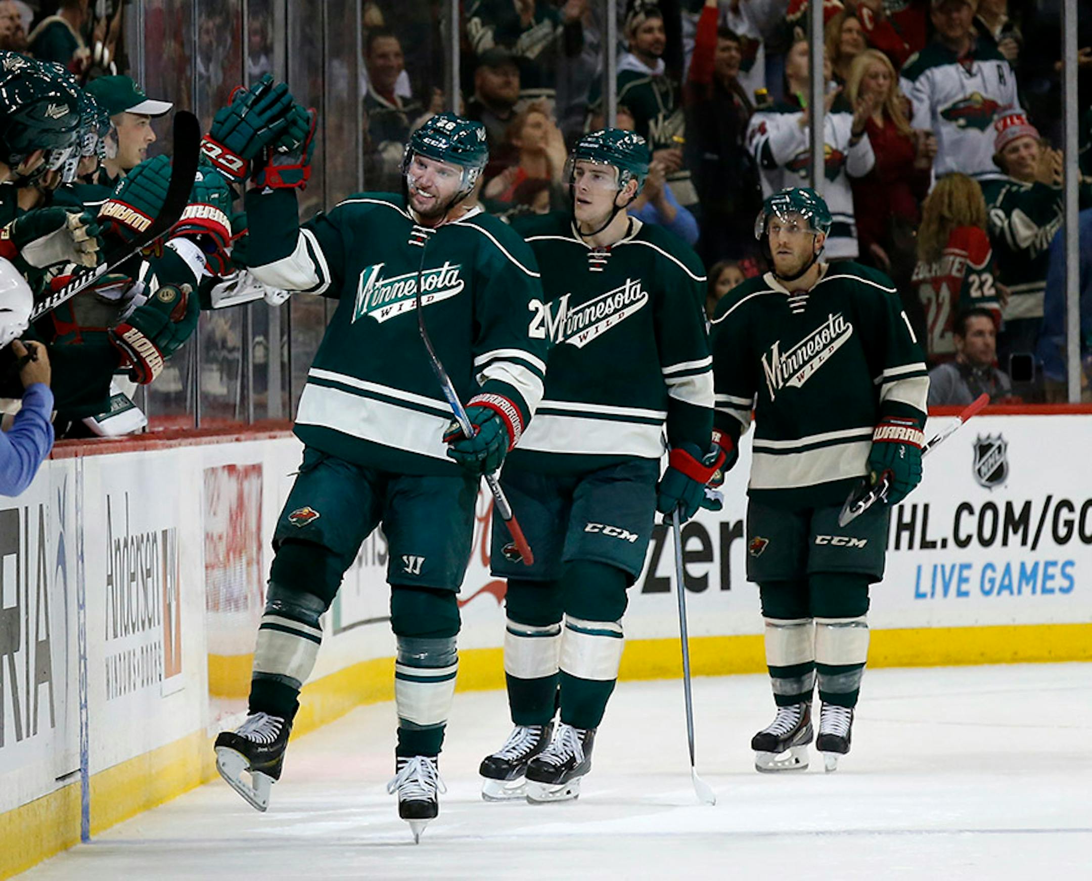Minnesota Wild left wing Thomas Vanek, left, of Austria, celebrates with teammates on the bench after scoring on St. Louis Blues goalie Jake Allen during the second period of an NHL hockey game in St. Paul, Minn., Saturday, Oct. 10, 2015. (AP Photo/Ann Heisenfelt)