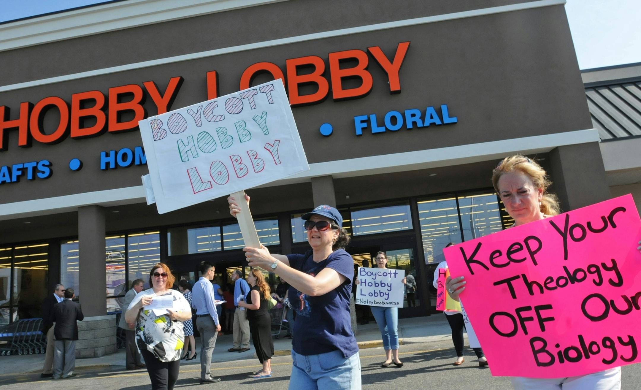 Diane Douthat of Wayne, left, and Ellen Taner, right, of Fair Lawn are among a dozen protesters outside of the Hobby Lobby on Route 46 west in Totowa, N.J., on Monday, July 7, 2014. (AP Photo/The Record of Bergen County, Elizabeth Lara) ONLINE OUT; MAGS OUT; TV OUT; INTERNET OUT; NO ARCHIVING; MANDATORY CREDIT ORG XMIT: MIN2014070812042043