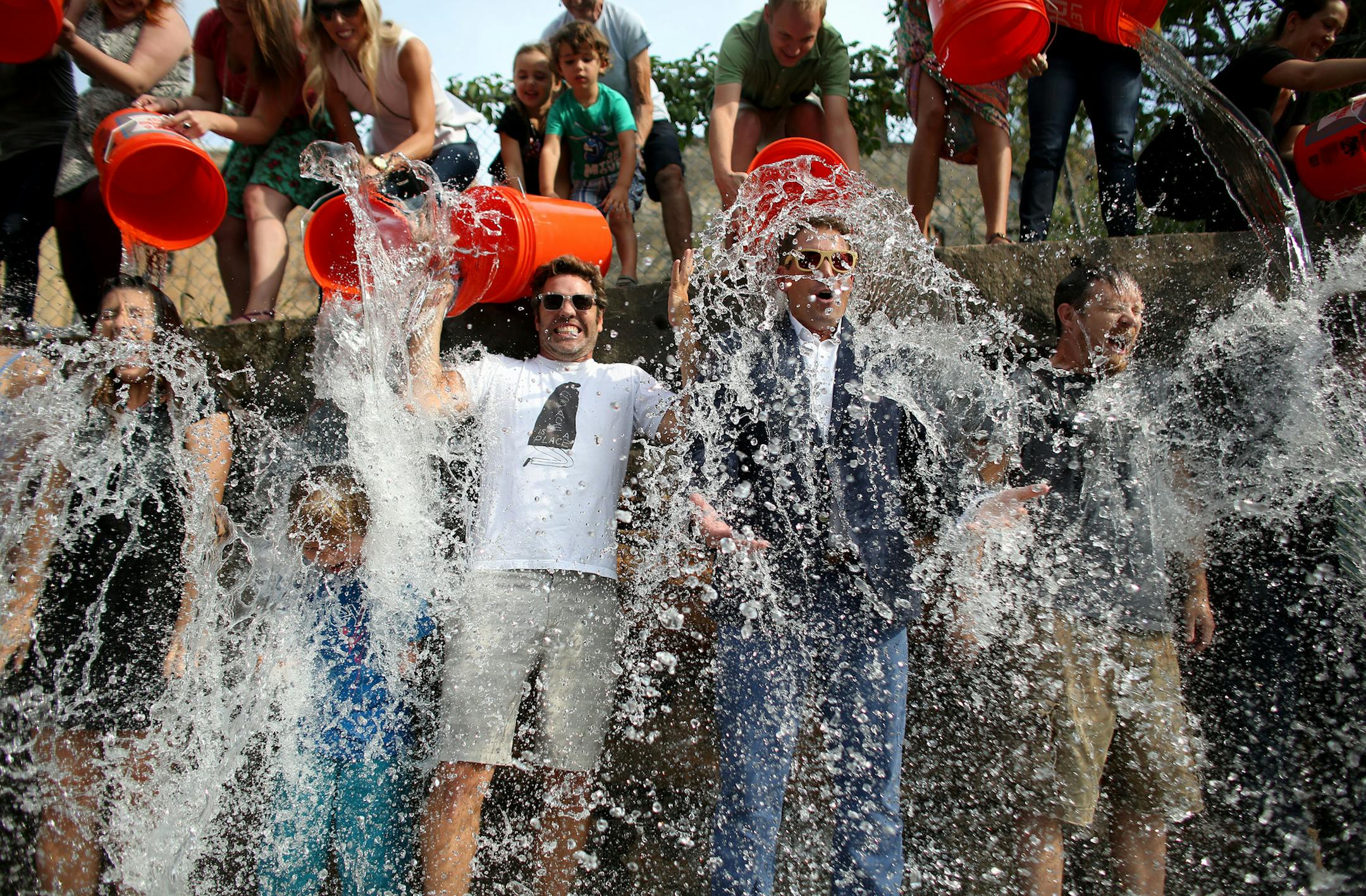 David Denim, president of space150 ad agency, in the suit, and owner Billy Jurewicz, in the white T-shirt along with employees and friends took the ice bucket challenge for ALS. ] (KYNDELL HARKNESS/STAR TRIBUNE) kyndell.harkness@startribune.com In a parking lot behind the building that houses space150 ad agency in Minneapolis Min., wednesday, August, 20, 2014. About 20 staff members at space150 ad agency in Minneapolis will be taking on the ice bucket challenge.