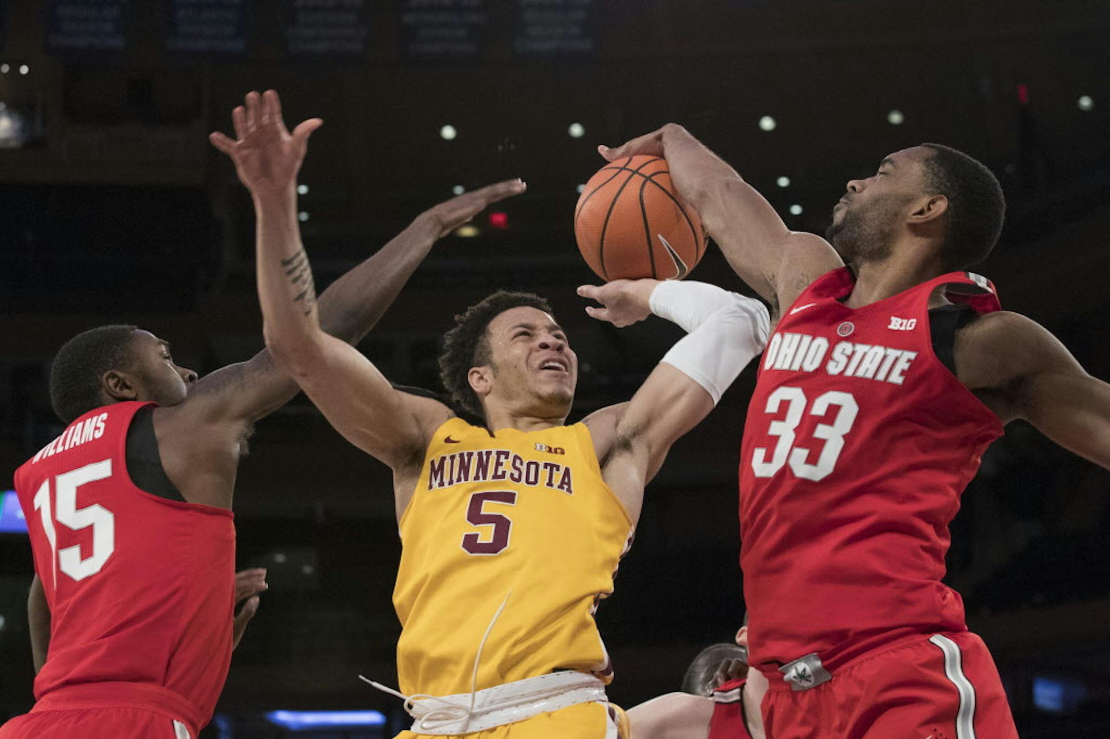 Ohio State guard Kam Williams (15) and forward Keita Bates-Diop (33) guard Minnesota guard Amir Coffey (5) during the first half of an NCAA college basketball game, Saturday, Jan. 20, 2018, at Madison Square Garden in New York. (AP Photo/Mary Altaffer)