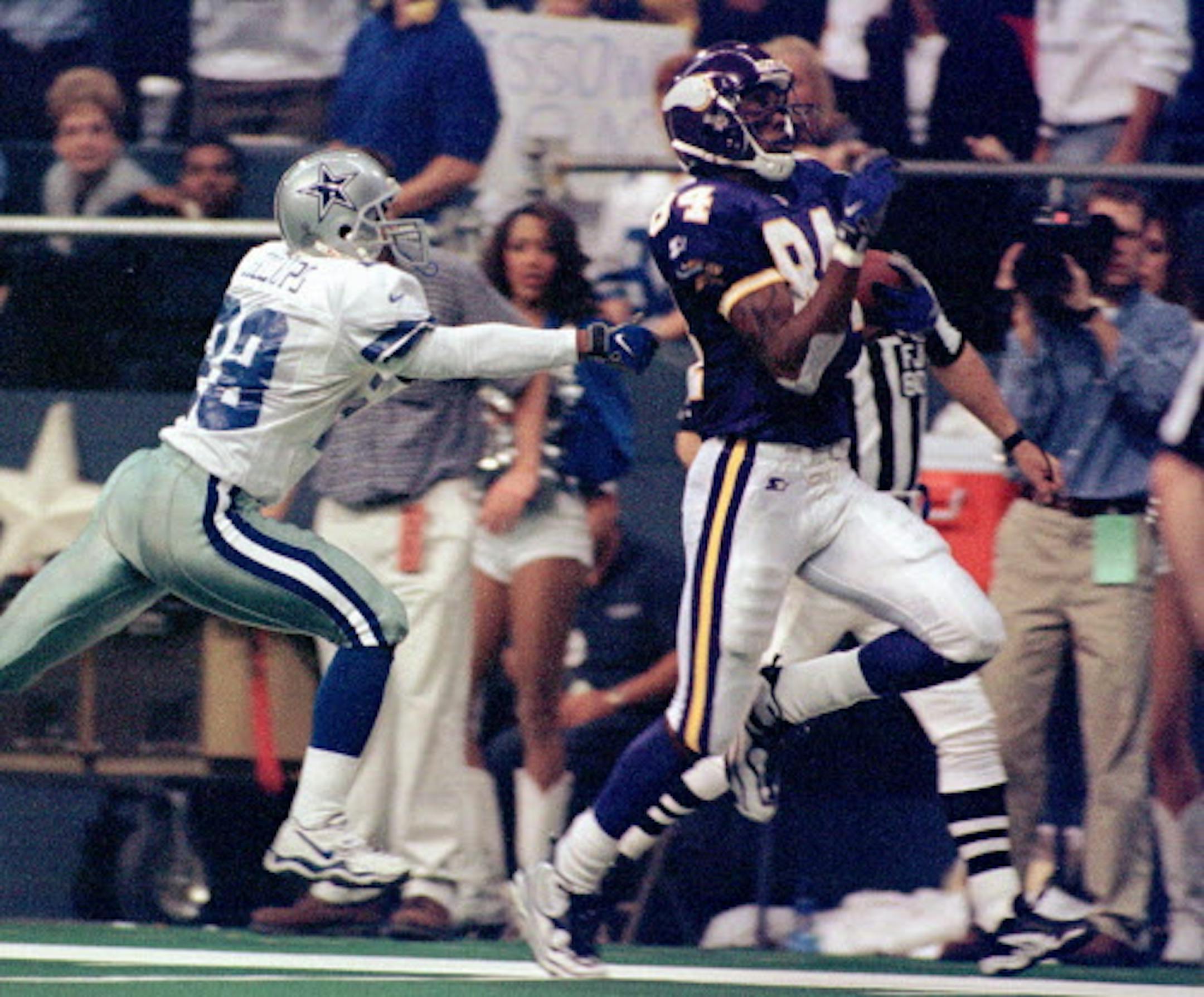 Minnesota Vikings wide receiver Randy Moss (84) runs for a 56-yard touchdown in the third quarter as Dallas Cowboys cornerback Terry Billups gives chase Thursday, Nov. 26, 1998, in Irving, Texas. Minnesota won 46-36. (AP Photo/Tim Sharp) ORG XMIT: IRV102