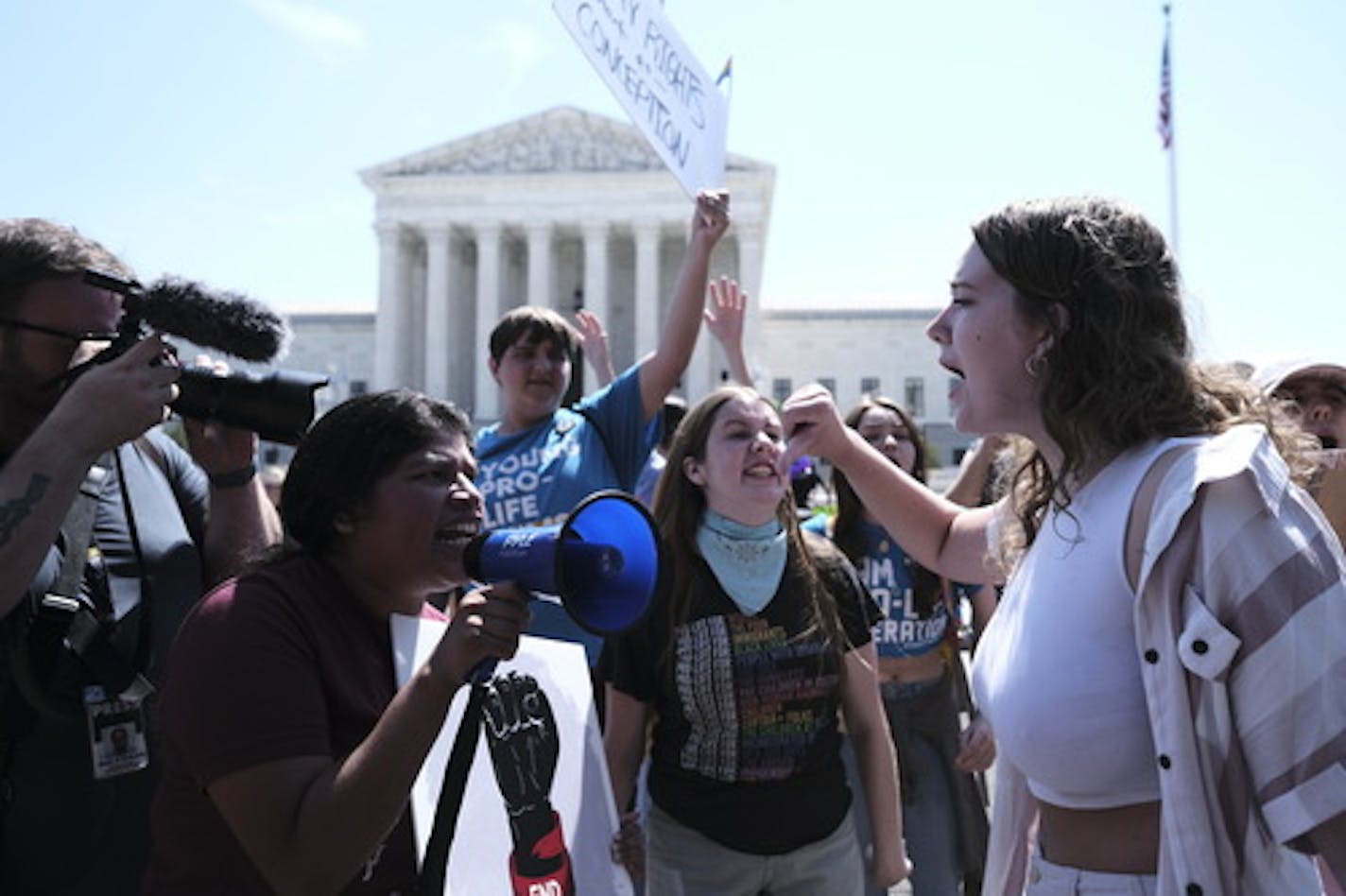 Demonstrators for and against abortion rights gather outside of the Supreme Court on the morning after the court overturned Roe v. Wade, effectively outlawing abortion in many states, in Washington, June 25, 2022. Around the country, a patchwork of laws took hold amid protest and celebration. (T.J. Kirkpatrick/The New York Times)