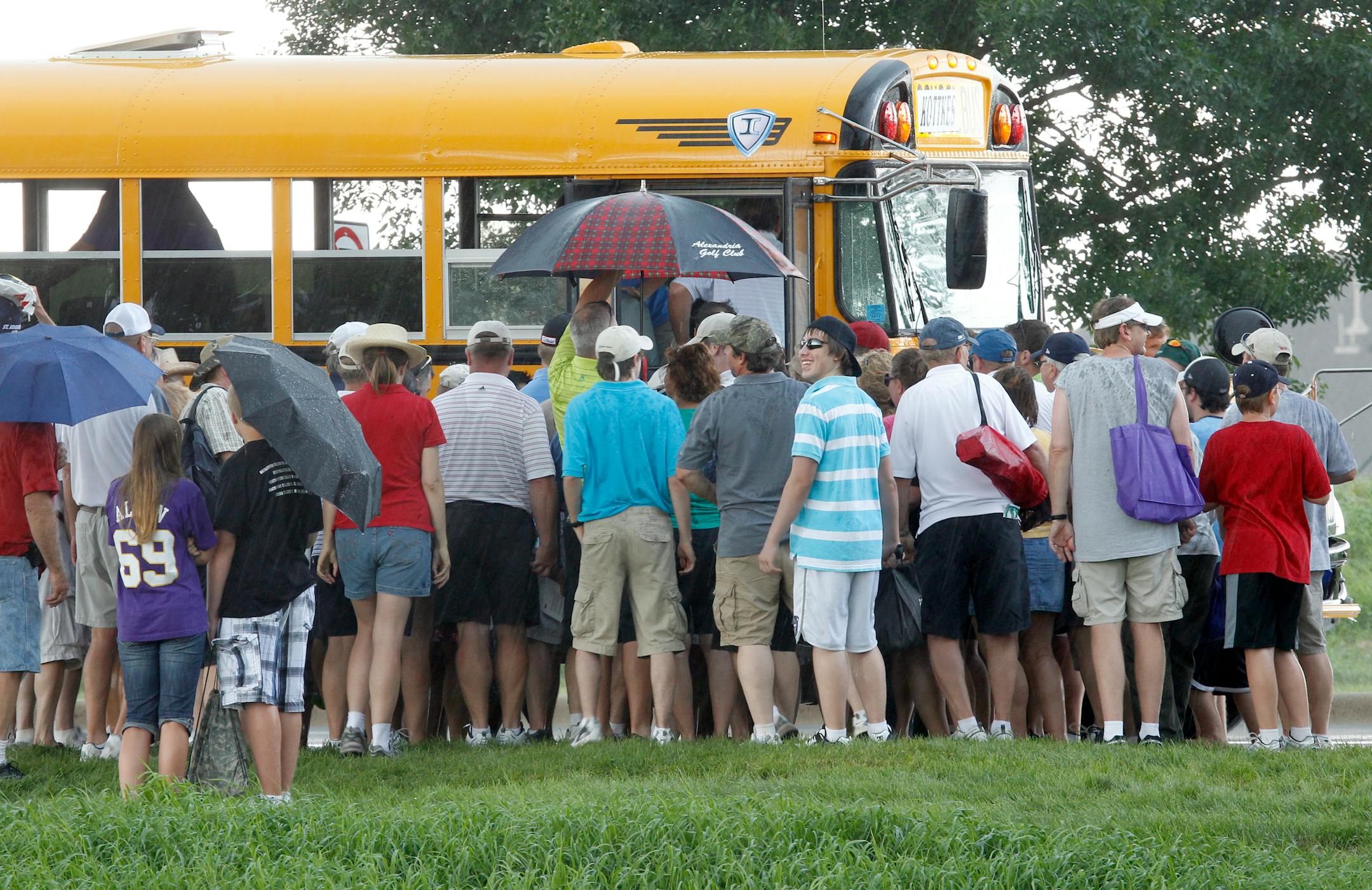 The buses loaded the crowd out of the area after play was suspended and the course was clear because of thunderstorms rolling over the course at Saturday's second round of The 3M Championship at TPC, Twin Cities in Blain , MN. ] TOM WALLACE • twallace@startribune.com __Assignments #20019060A_ August 6, 2011_ SLUG: 3m0807_ EXTRA INFORMATION: Photo take from the 3M Championship, TPC Twin Cities, Blaine.
