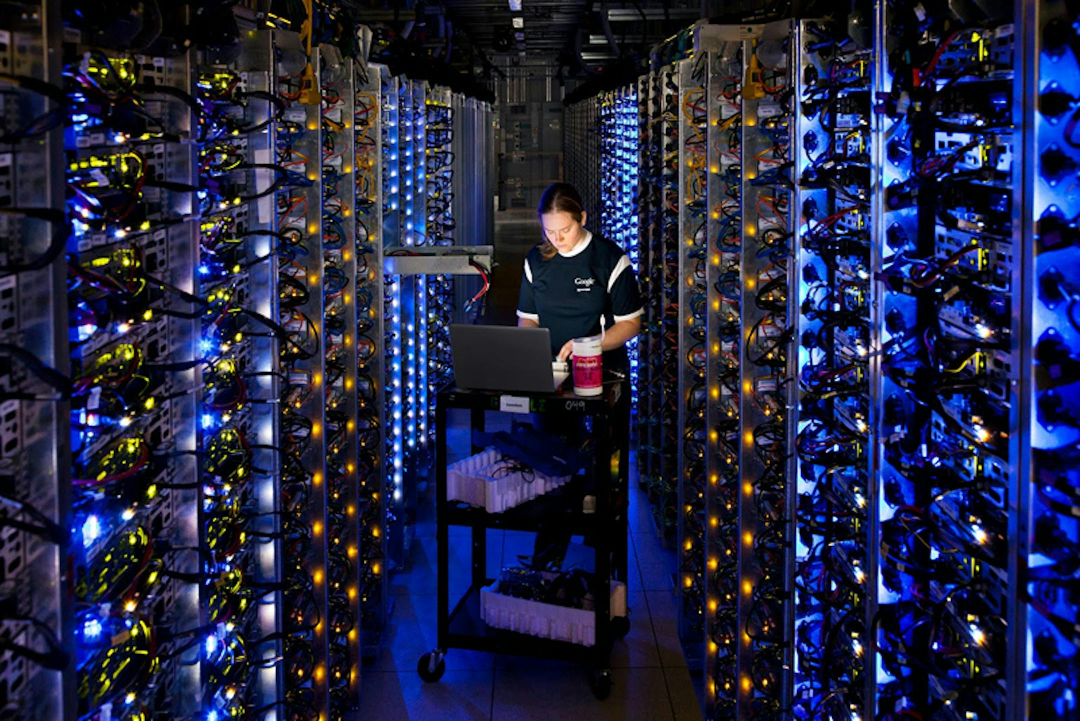 This undated photo provided by Google shows a Google technician working on some of the computers in the Dalles, Ore., data center.
