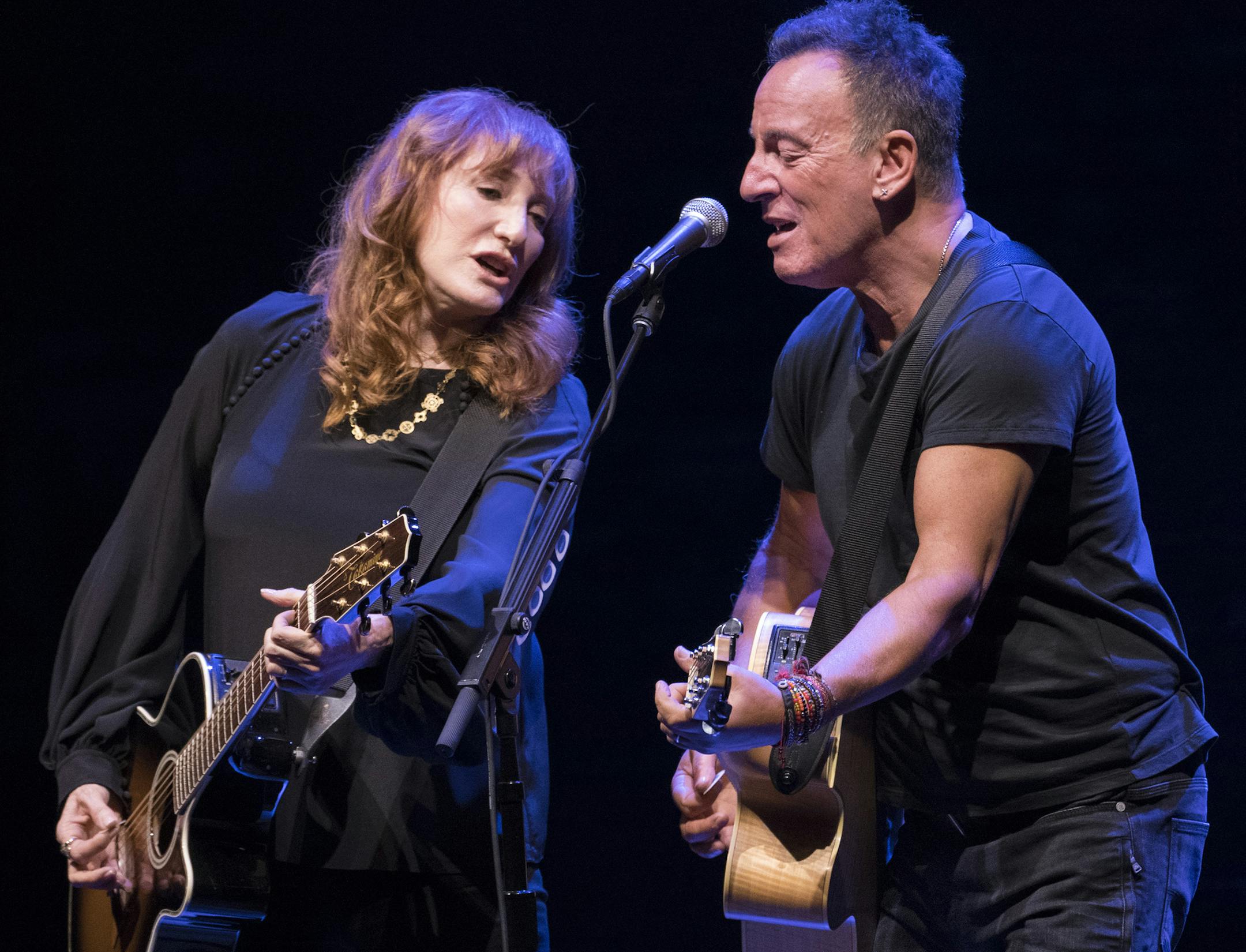 Bruce Springsteen and his wife Patti Scialfa in "Springsteen on Broadway," an evening of singing and storytelling, at the Walter Kerr Theater in New York, Oct. 12, 2017. The show raked in $2.33 million last week from just five performances. Even more striking than the overall gross was the average ticket price at the Springsteen show: $497. (Sara Krulwich/The New York Times) ORG XMIT: XNYT124