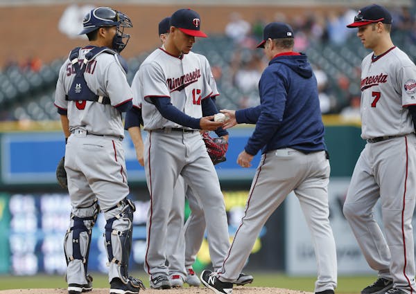Twins manager Paul Molitor, right, took the ball from pitcher Jose Berrios against the Tigers in the first inning Monday.