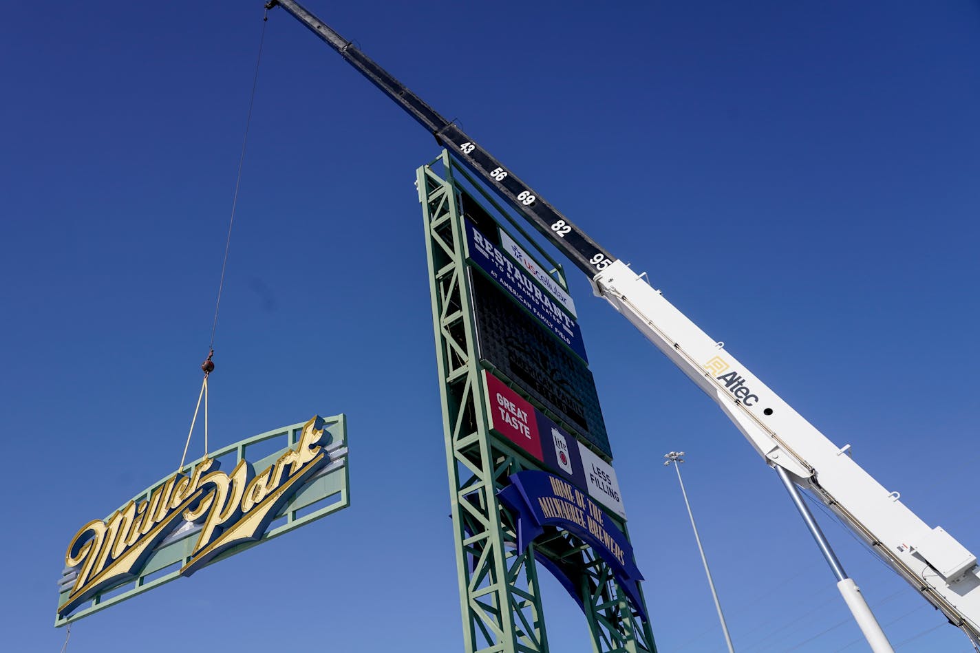 Workers remove a Miller Park sign before replacing it with an American Family Field sign Wednesday, Jan. 27, 2021, in Milwaukee. The sign replaces the Miller Park sign after American Family bought the naming rights to the home of the Milwaukee Brewers. (AP Photo/Morry Gash)