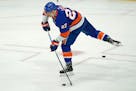 New York Islanders center Anders Lee (27) takes a shot during pregame warmups before an NHL hockey game against the Pittsburgh Penguins, Thursday, Feb
