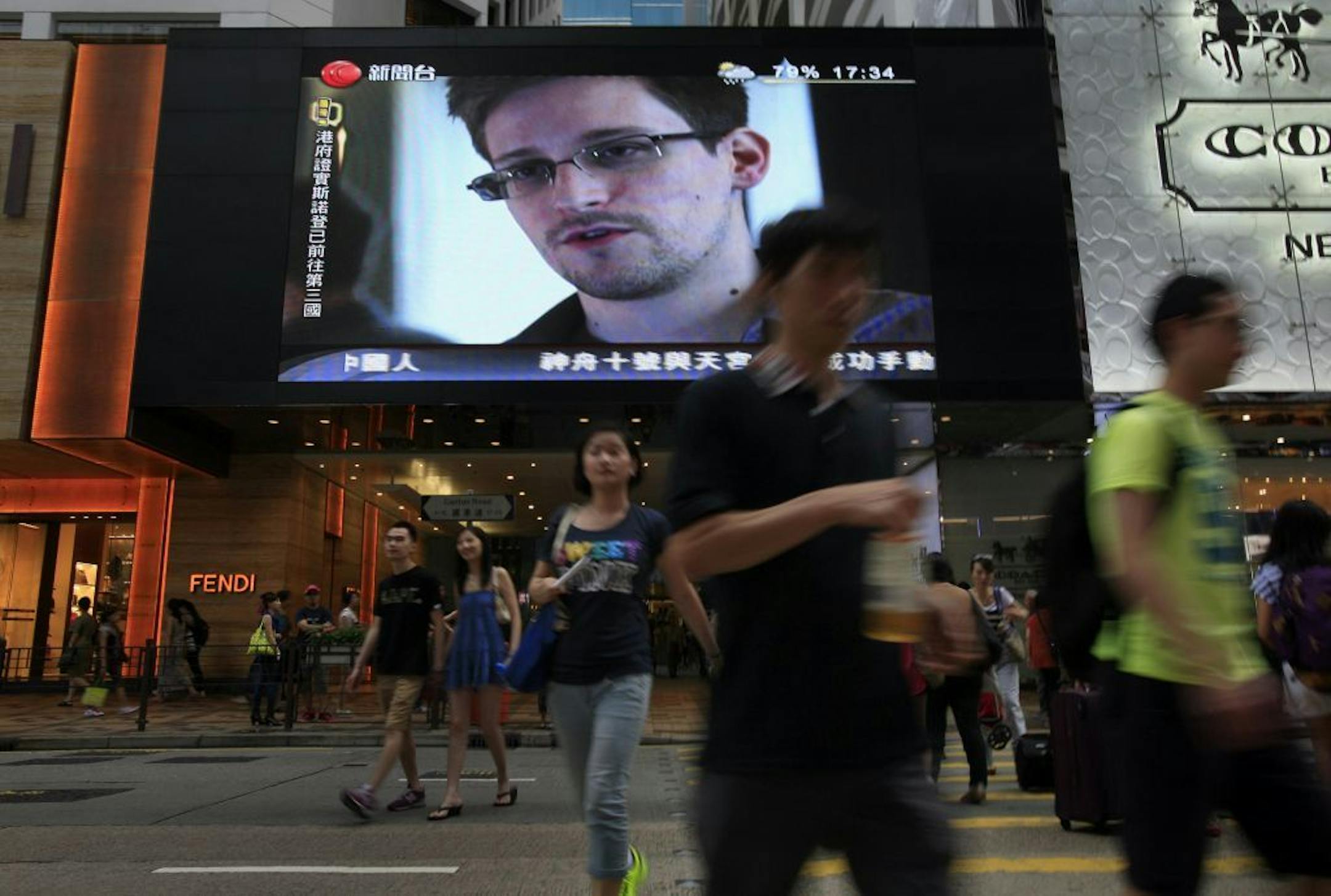 FILE - This June 23, 2013 file photo shows a TV screen shows a news report of Edward Snowden, a former CIA employee who leaked top-secret documents about sweeping U.S. surveillance programs, at a shopping mall in Hong Kong. President Barack Obama brushed aside sharp European criticism on Monday, suggesting all nations spy on each other, as the French and Germans expressed outrage over alleged U.S. eavesdropping on European Union diplomats. American analyst-turned-leaker Edward Snowden, believed