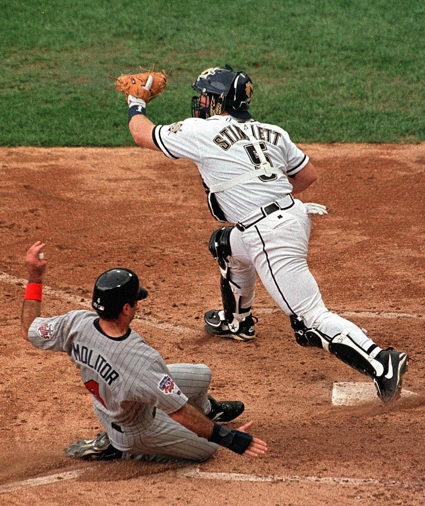 Minnestota Twins designated hitter Paul Molitor slides home past Milwaukee Brewers catcher Kelly Stinnett in the fourth inning Thursday, July 3, 1997, in Milwaukee. Molitor scored from third on an error. (AP Photo/Morry Gash)