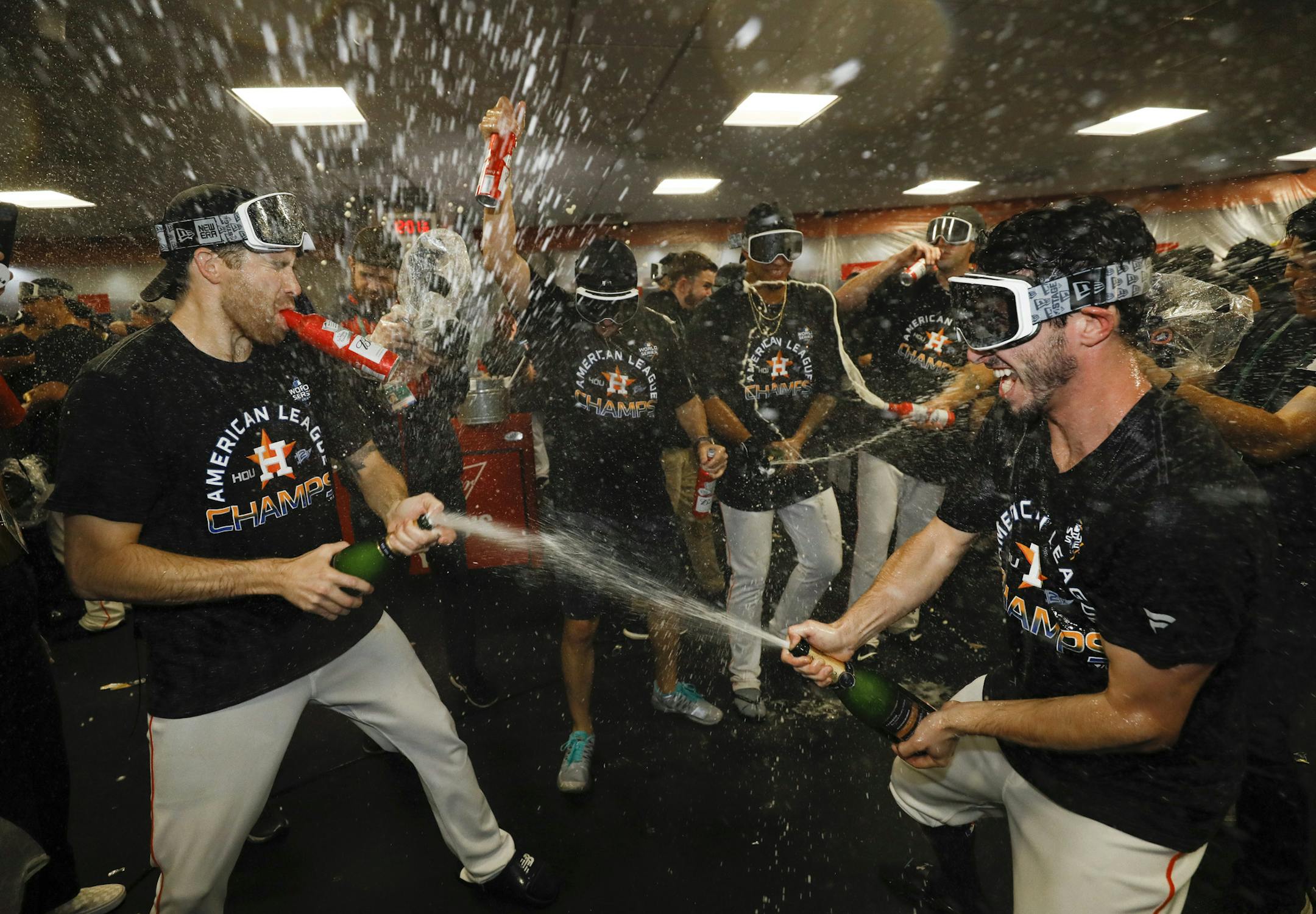 Houston Astros in the locker room after winning Game 6 of baseball's American League Championship Series against the New York Yankees Sunday, Oct. 20, 2019, in Houston. The Astros won 6-4 to win the series 4-2. (AP Photo/Matt Slocum)
