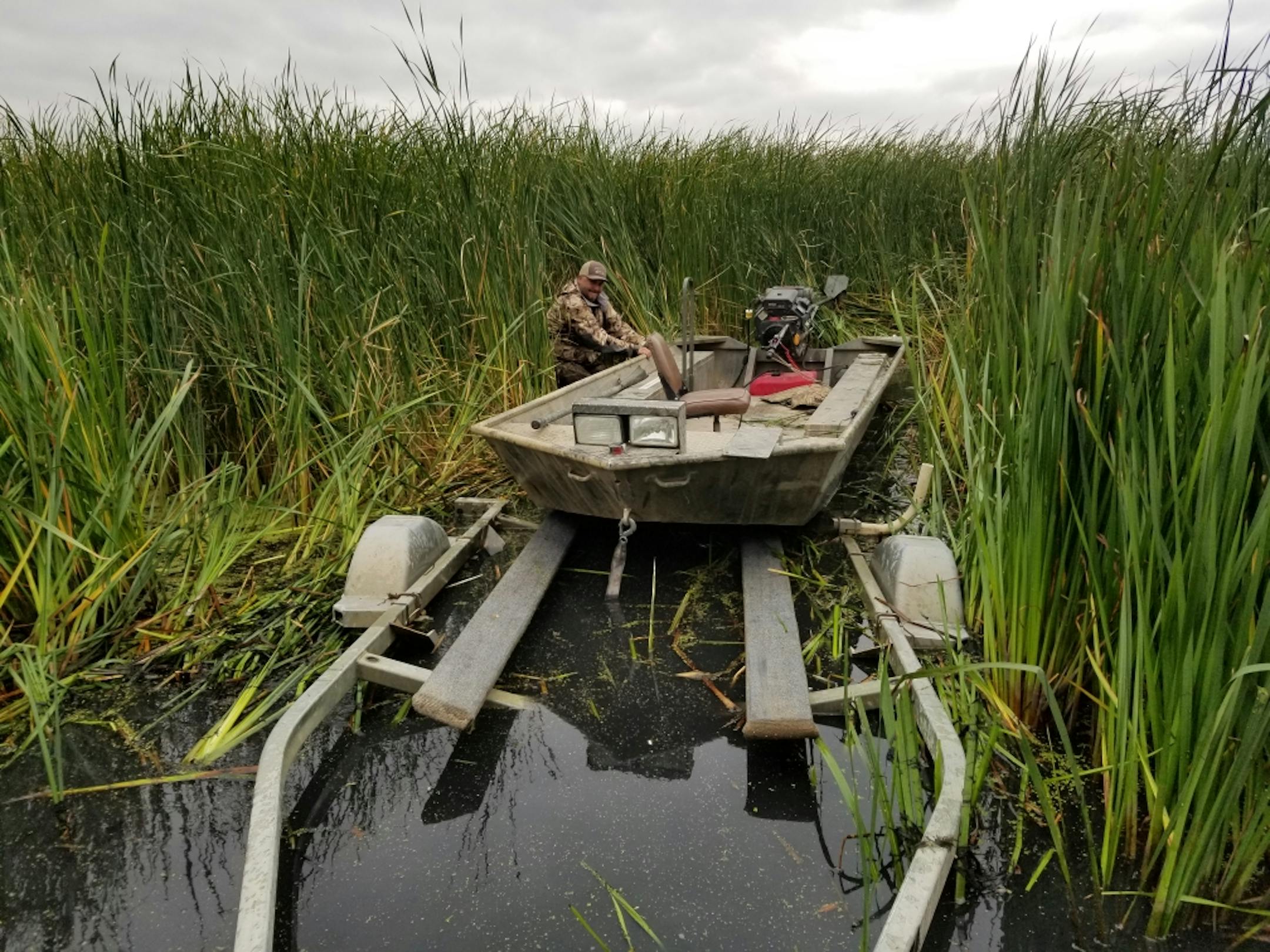 Pete Bohlig loads his duck hunting boat on Marsh Lake on Friday after making a scouting trip in advance of Saturday's duck opener.