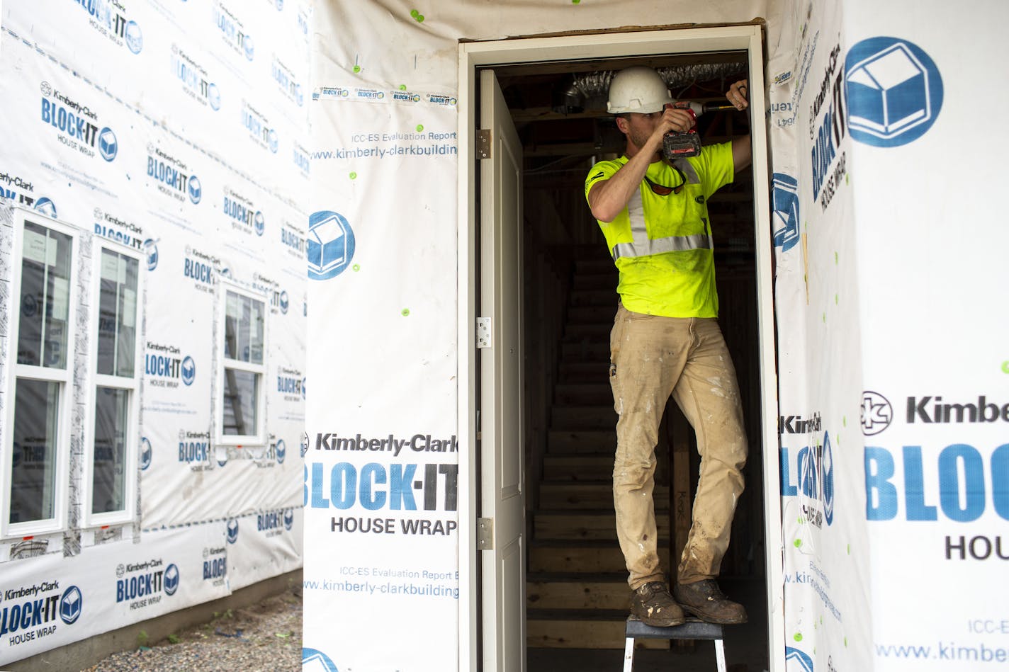 The Twin Cities saw a 21% increase in single family building permits in March compared with the same period a year ago. In this June 2019 photo, Alex Flaschenriem works on a door frame on a house in the Donegal neighborhood. (Staff photo: NICOLE NERI/nicole.neri@startribune.com) ORG XMIT: MIN1906271701452981