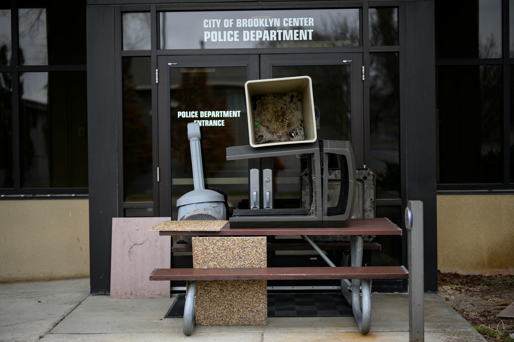 Protesters previously built a barricade outside the entrance of the Brooklyn Center Police Department with items found outside.