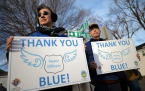 Ruth and Paul Larsen of Lakeville supported law enforcement Tuesday outside Ballard-Sunder Funeral and Cremation in Jordan. “They don’t know if th