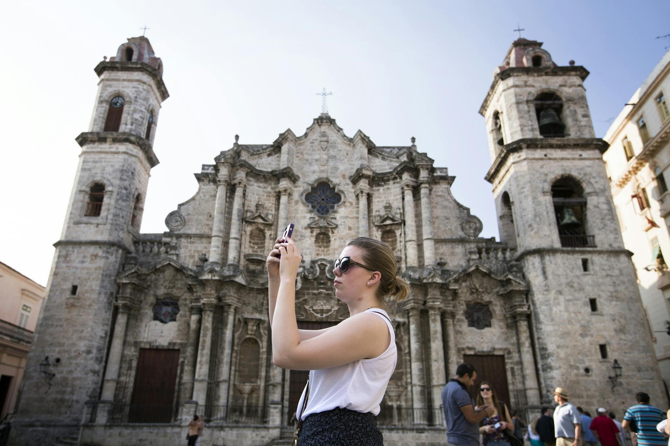 Sarah Grimes, a violinist in the Minnesota Orchestra, takes photos in Plaza de la Catedral in Old Havana, Cuba on Wednesday, May 13, 2015.