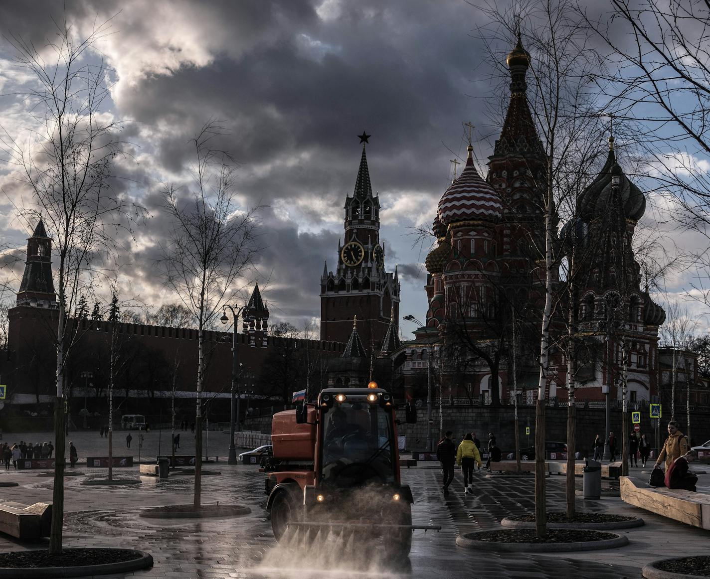 FILE -- Workers clean a park next to the Kremlin and St. Basil Cathedral in Moscow, Thursday, March 19, 2020. Kremlin-aligned websites aimed at Western audiences have trafficked in conspiracy theories to spread fear in Europe and political division in the United States, officials say. (Sergey Ponomarev/The New York Times)