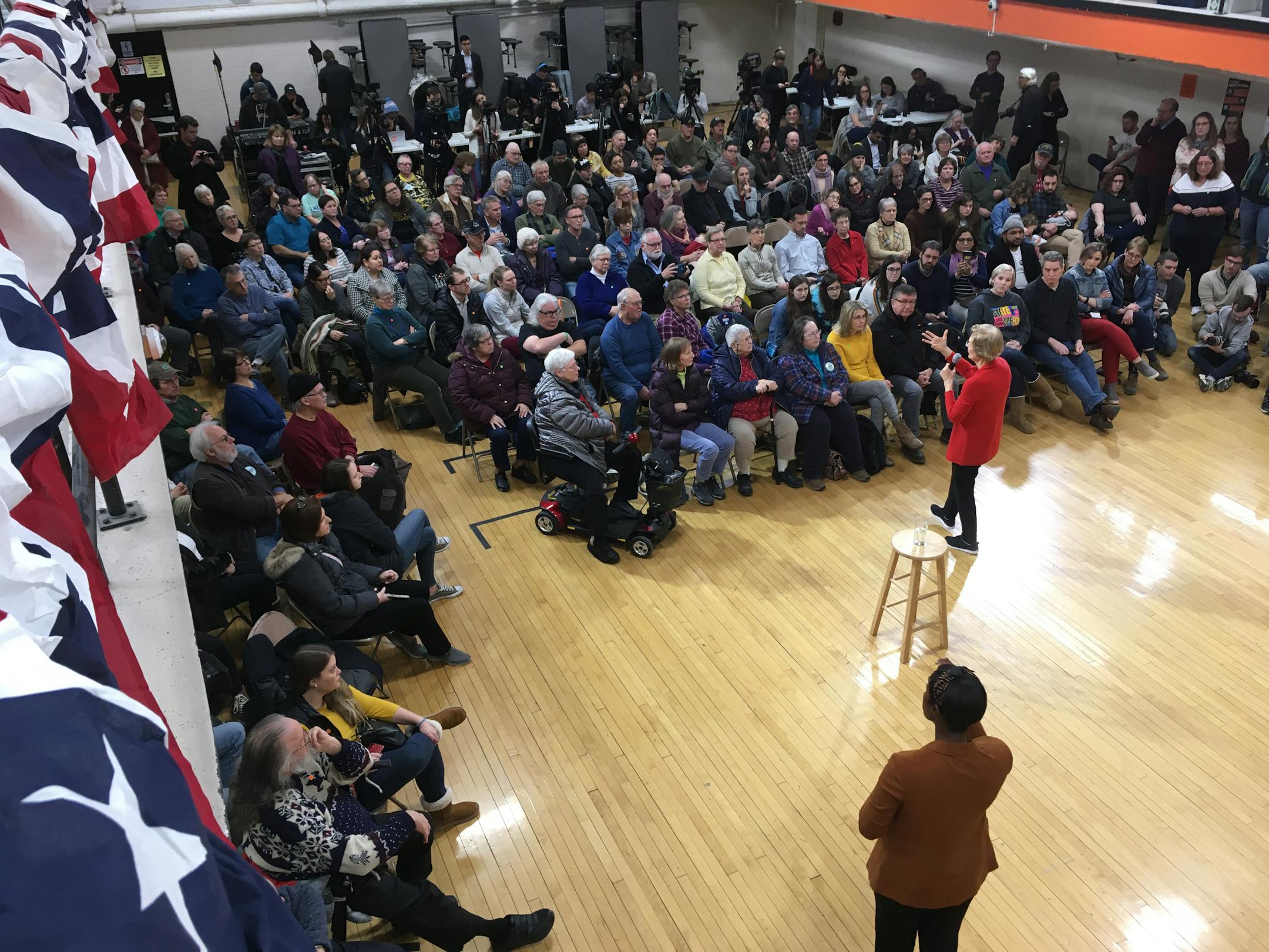 Democratic presidential candidate Elizabeth Warren campaigning in Iowa. During an event in a middle-school gymnasium, one woman's question to the candidate about health care turned into a conversation following an inquiry from the back of the room.