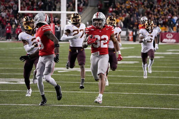 Running back TreVeyon Henderson (32) of the Ohio State Buckeyes carries the ball during the third quarter against the Minnesota Golden Gophersat Ohio 