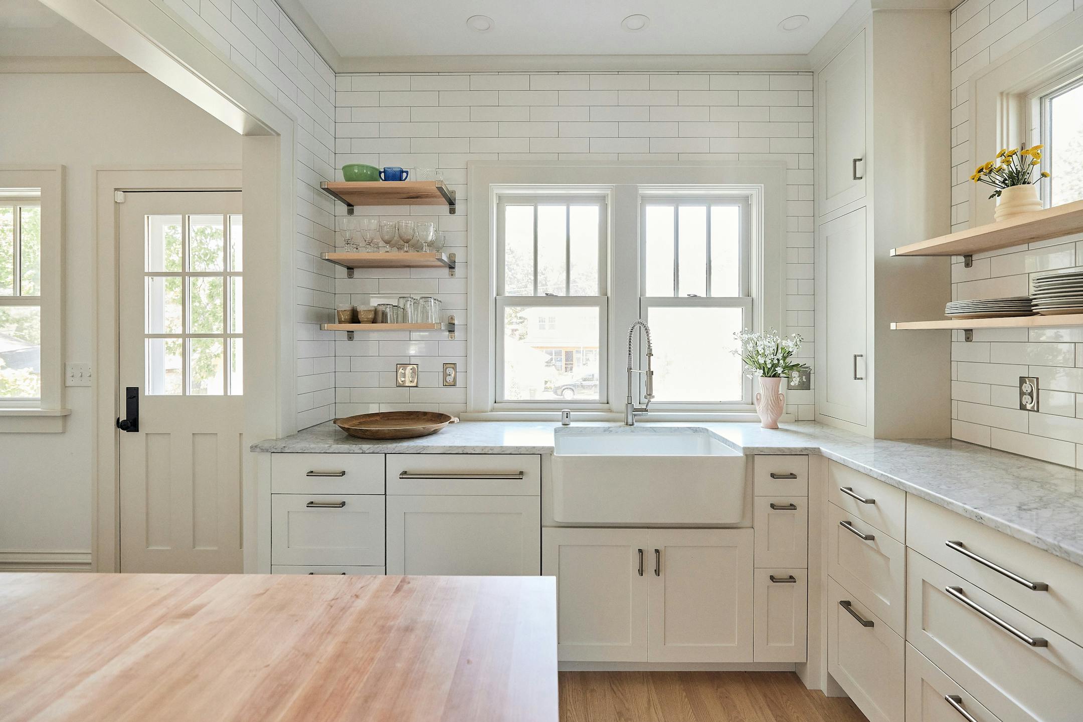 Merriam Park Cottage Renewal, a 2024-2025 Home of the Month winner by Albertsson Hansen Architecture and Interior Design, is a modest 1 1/2-story house that gets an overhaul while maintaining its vintage feel. An addition to a 1916 St. Paul home increases the kitchen’s square footage, adds a small covered porch with easier access to the backyard and expands the second floor to accommodate three bedrooms. Existing spaces are opened up to create better flow between gathering areas. White shaker-style cabinets and trim, as well as tall windows, add airiness and lightness.