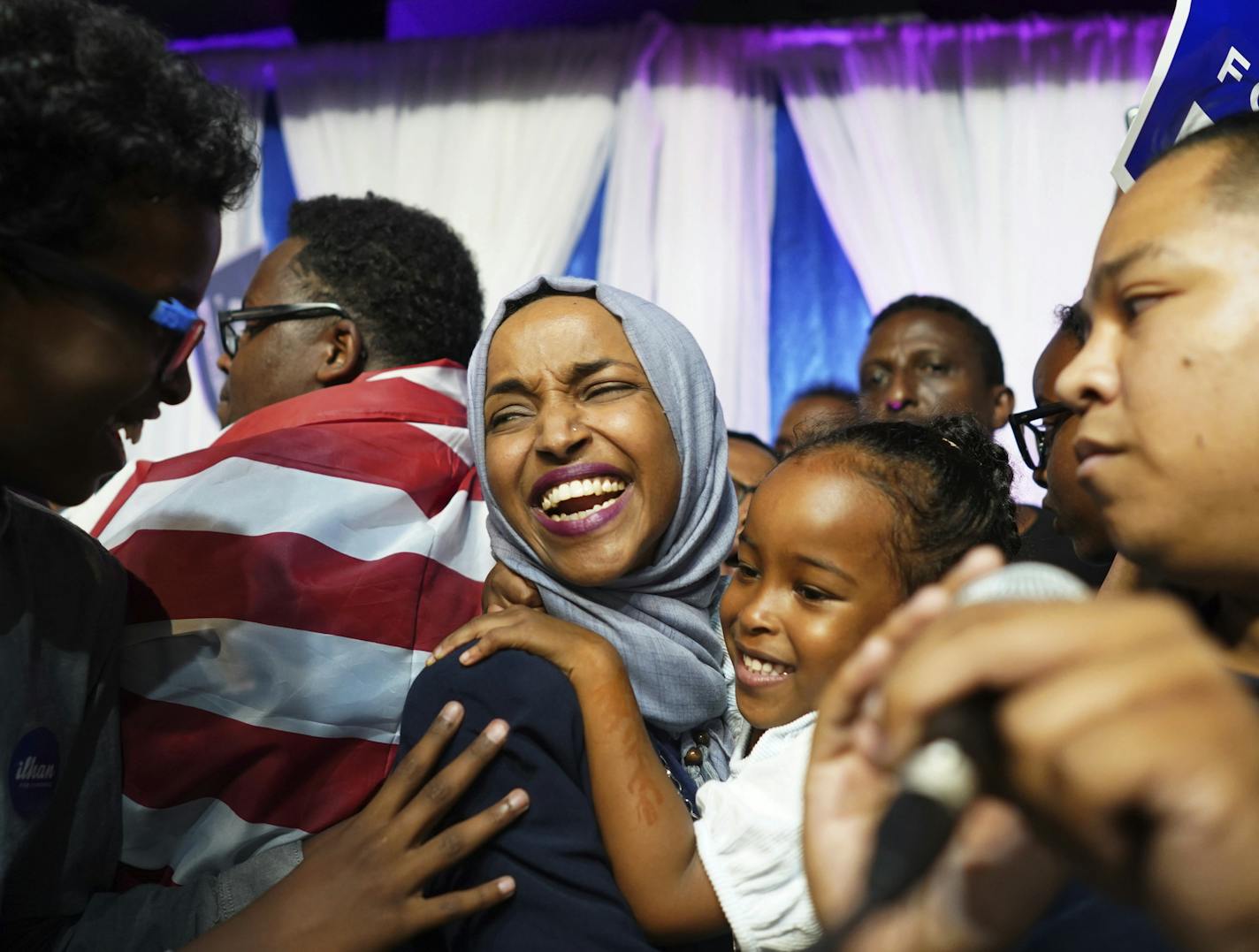 Minnesota Rep. Ilhan Omar, center, celebrates with her children after her Congressional 5th District primary victory, Tuesday, Aug. 14, 2018, in Minneapolis.