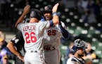 Minnesota Twins' Byron Buxton (25) is congratulated by Max Kepler (26) after hitting a two-run home run during the seventh inning of an opening day ba