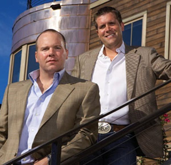 Former president Ryan Gilbertson and former CEO Michael Reger in happy times at Wayzata-based Northern Oil & Gas, which has an uncertain future amid o