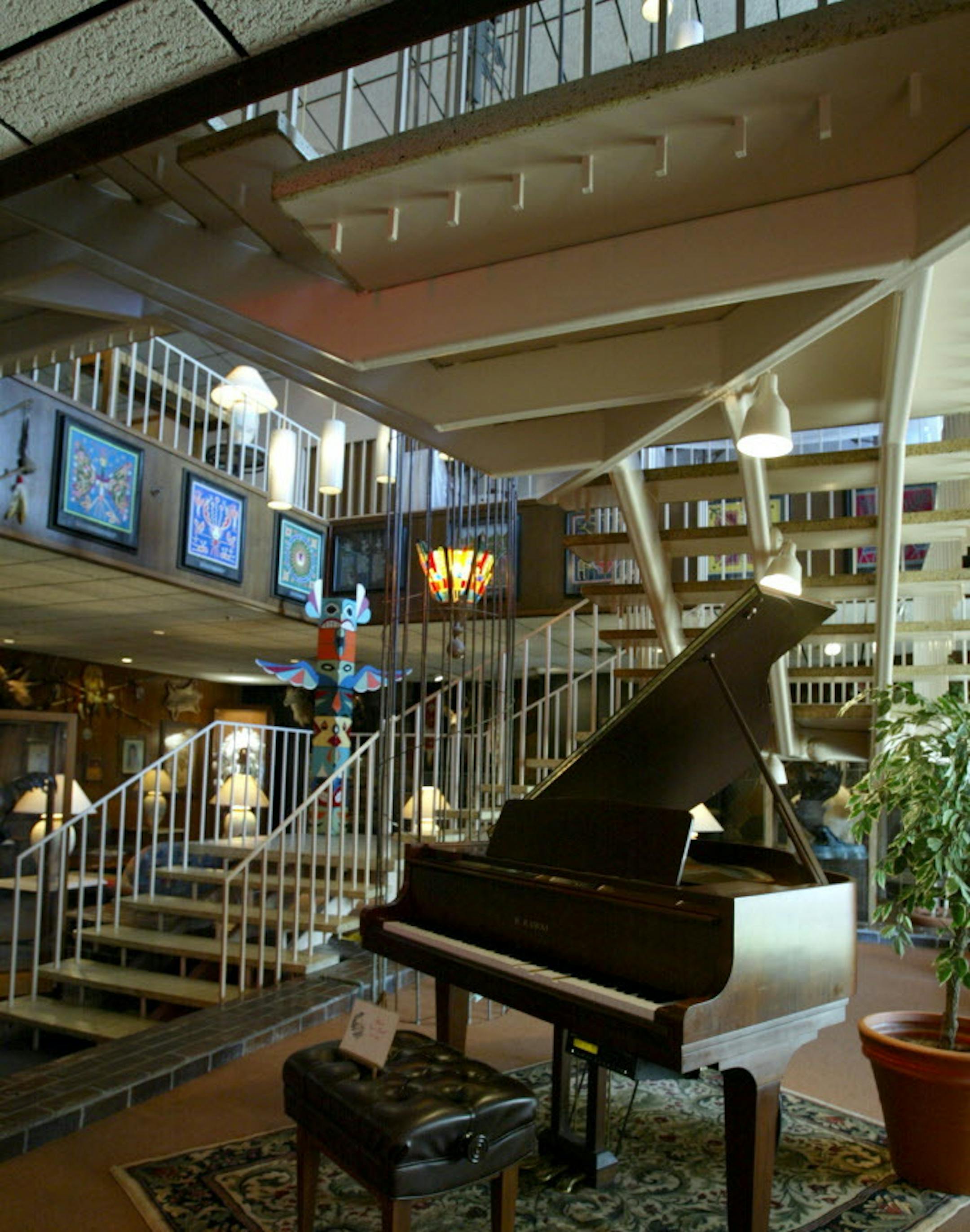 The interior lobby of the Thunderbird Motel in 2003 included an open staircase and lighting fixtures decending on cables, echoing a 1960s style.