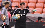 New Minnesota goalkeeper coach Stewart Kerr, right, works with backup rookie goalkeeper Dayne St. Clair on the field Wednesday at Houston.