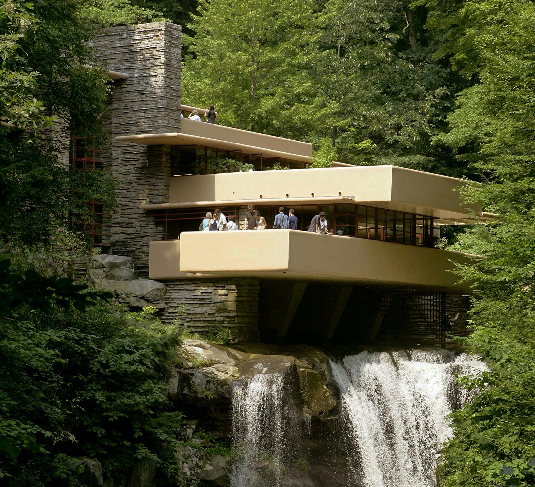 FILE - This Aug. 23, 2007, file photo, visitors gather on one of the cantilevered terraces at Fallingwater, a Frank Lloyd Wright design in Bear Run, Pa. Eight buildings, including the Fallingwater, designed by the architect during the first half of the 20th century, where honored as World Heritage sites by United Nations Educational, Scientific and Cultural Organization, or UNESCO, on Sunday, July 7, 2019. (AP Photo/Keith Srakocic, File)