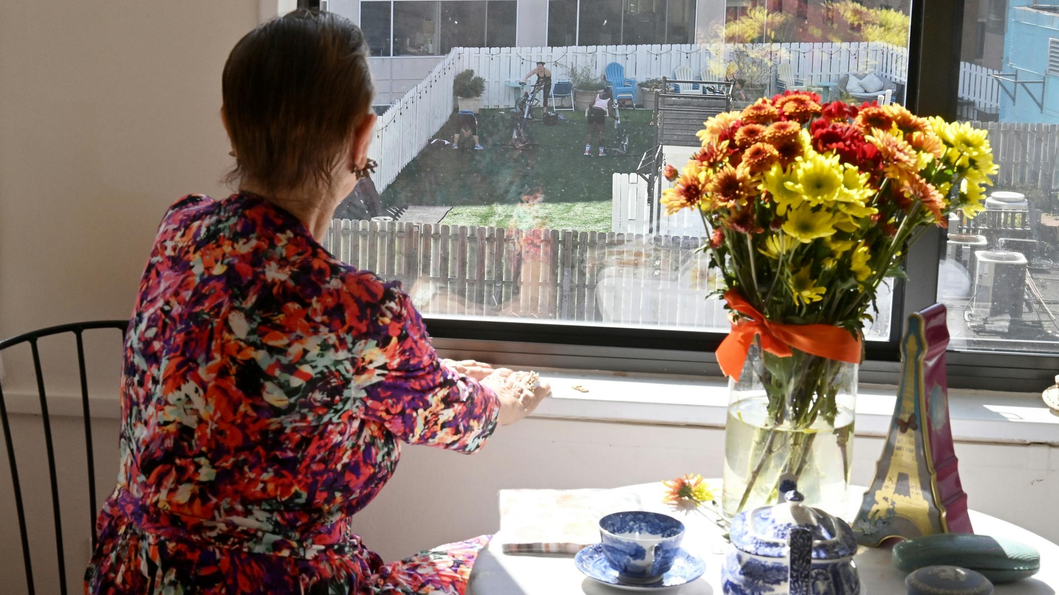 Tessa Sollom Williams, 90, lives in an assisted-living apartment and watches every day from her window as members of Balance Gym at Thomas Circle exercise on the roof of the gym.