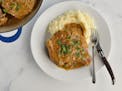 Pork chops are smothered in a maple-mustard sauce and served with mashed potatoes.